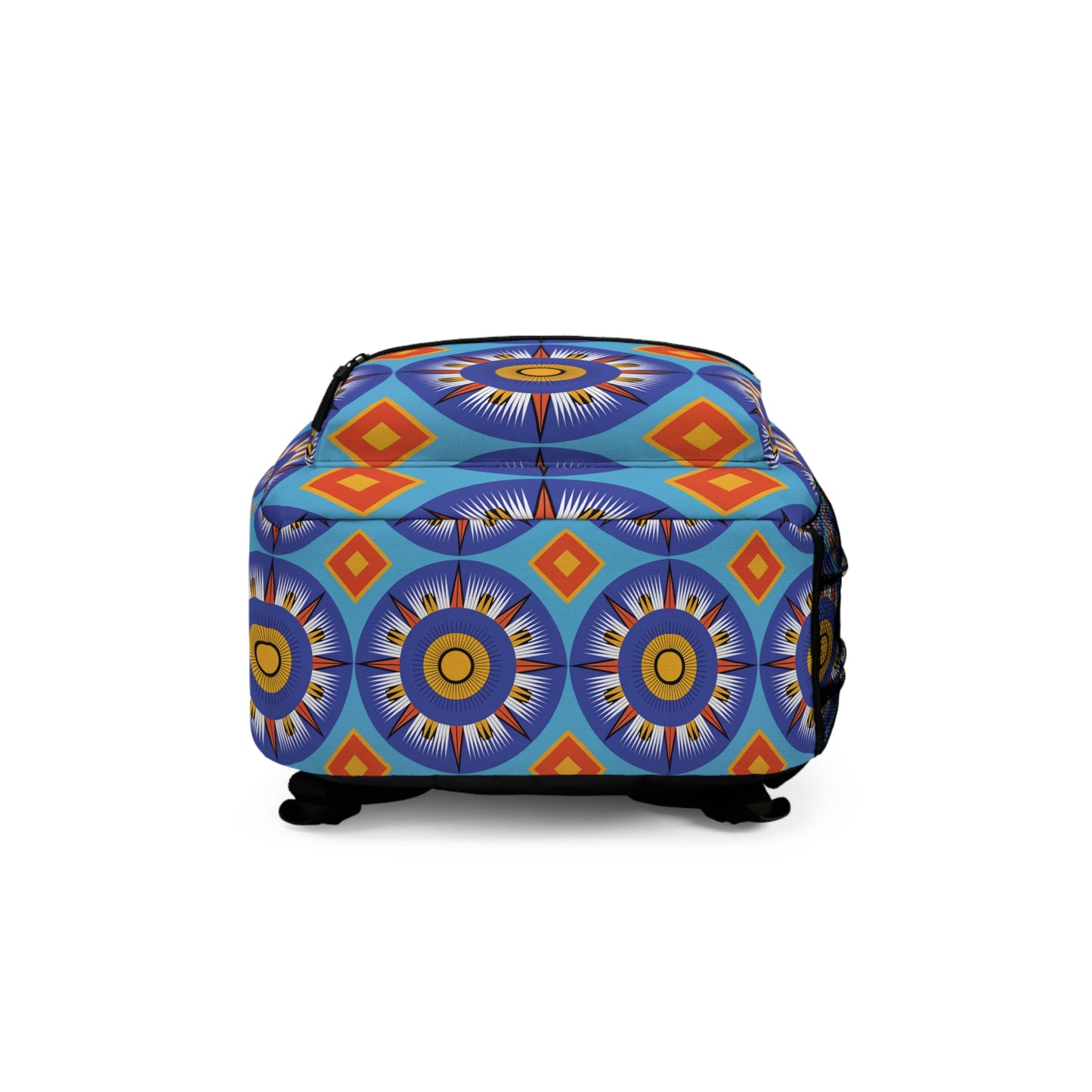 A colorful ottoman with a vibrant geometric pattern in blue, yellow, orange, and red. Reminiscent of a boho chic rucksack, its circular sunburst shapes and diamond motifs create a bold, artistic look. The ottoman has short black legs and a soft fabric texture.
