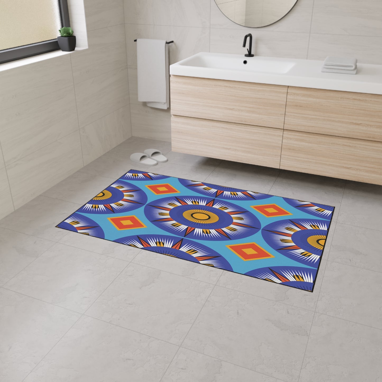 A modern bathroom with light beige tiles and a wooden vanity. A colorful geometric rug, featuring African-inspired aesthetics, lies on the floor. The rug’s non-slip rubber backing ensures safety, while white slippers rest near the wall under a towel rack.