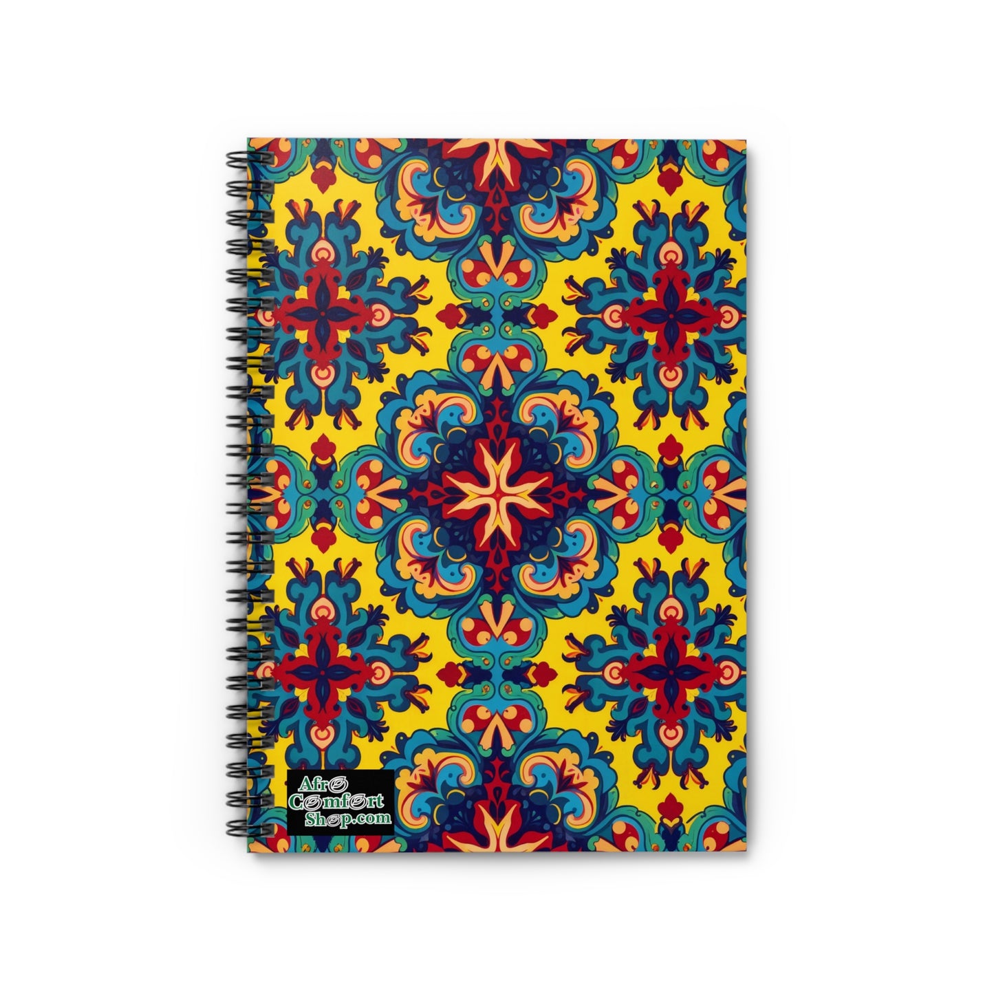 A premium writing journal featuring a vibrant, symmetrical pattern of blue, red, and orange floral motifs on a yellow background. The bottom left corner displays the “Adios Comfort shop.com” logo in white text with a black outline.