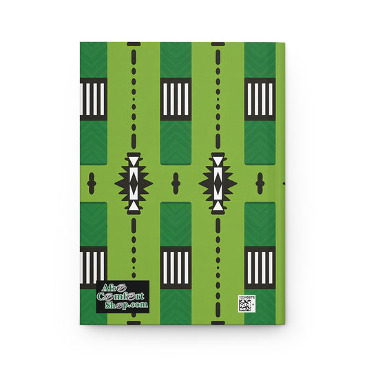A hardcover African-inspired journal with a green cover, bold geometric patterns in black, white, and dark green. The bottom left features the AfroComixArtshop.com logo, while a QR code sits in the bottom right corner. Perfect as a unique wellness journal.