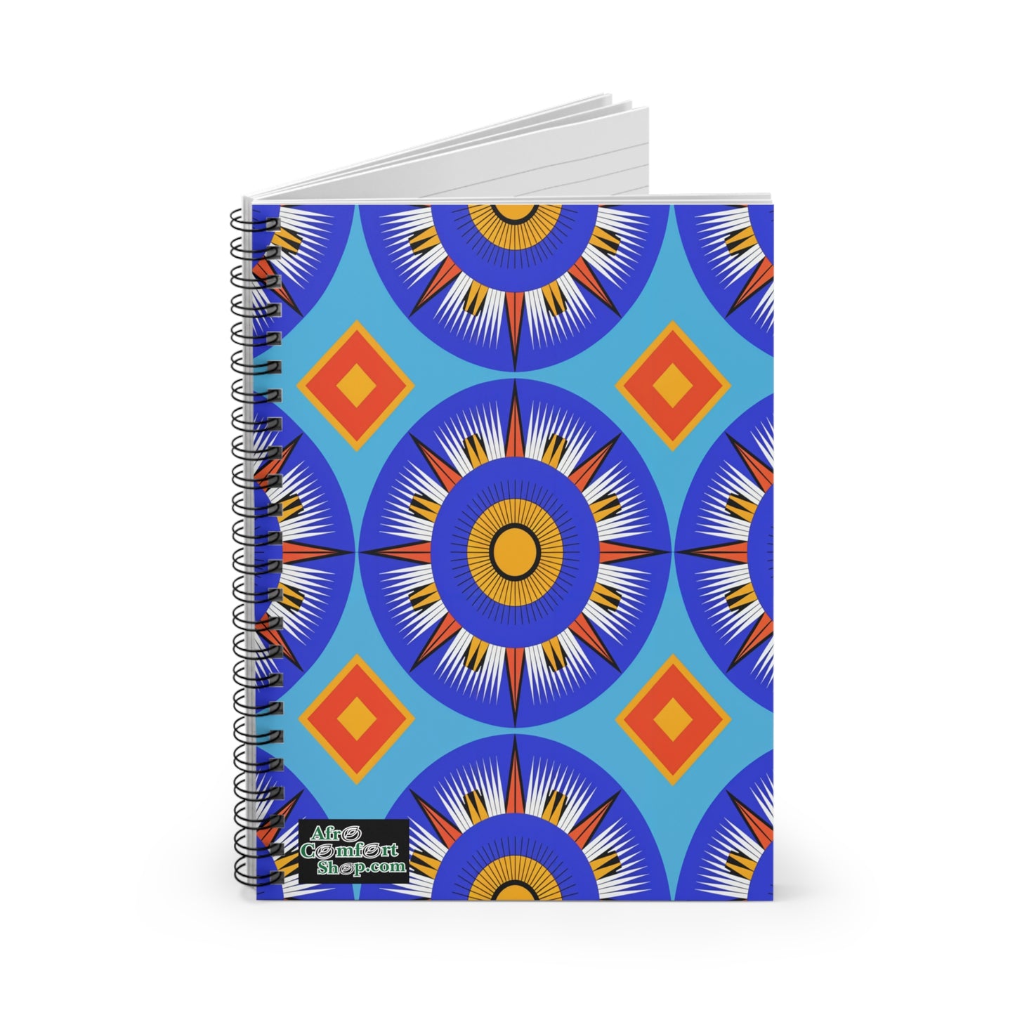 A spiral notebook with a vibrant cover featuring culturally inspired designs—bold blue, orange, yellow, and white starburst circles with red diamonds on blue. The lower left corner displays a small “Afro Conscient Shop.com” logo.