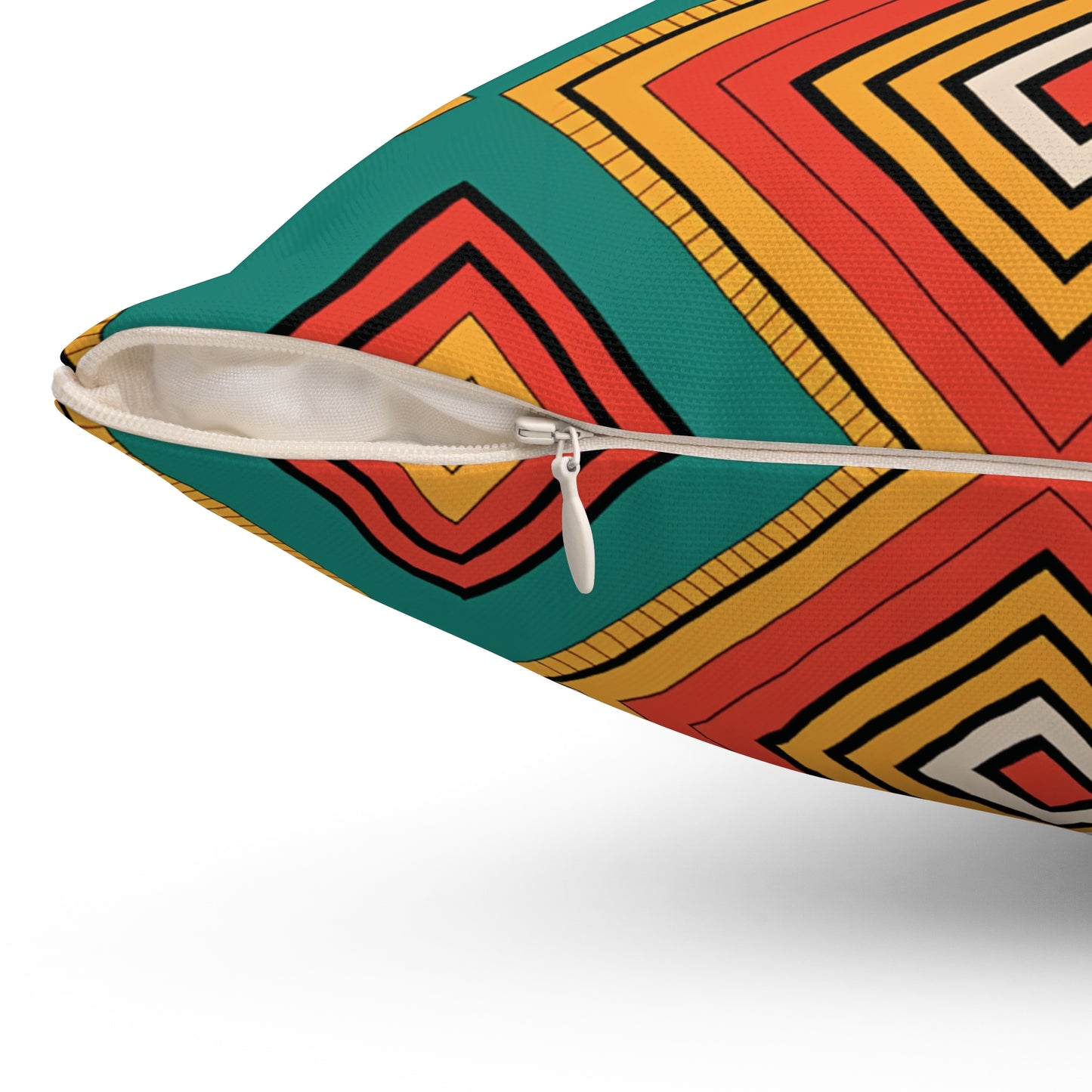 Close-up of a pillow with a white zipper partially open, revealing the edge of the insert. The fabric’s vibrant geometric pattern and diamond shapes add cultural flair, making it perfect for those who love bold, African-inspired pillows.