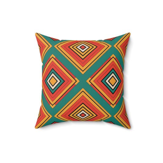 A square African accent pillow with a bold geometric pattern of nested diamonds in orange, red, yellow, and black on a dark teal background. Symmetrical shapes and crisp lines create a vibrant, modern look. The pillow is centered on a white backdrop.
