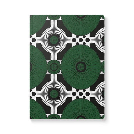 A creative journal with a cover featuring a geometric pattern of large green circles and radiating lines, intersected by white circles with black dots on a black background. This African-inspired journal offers a bold, modern, and symmetrical look.