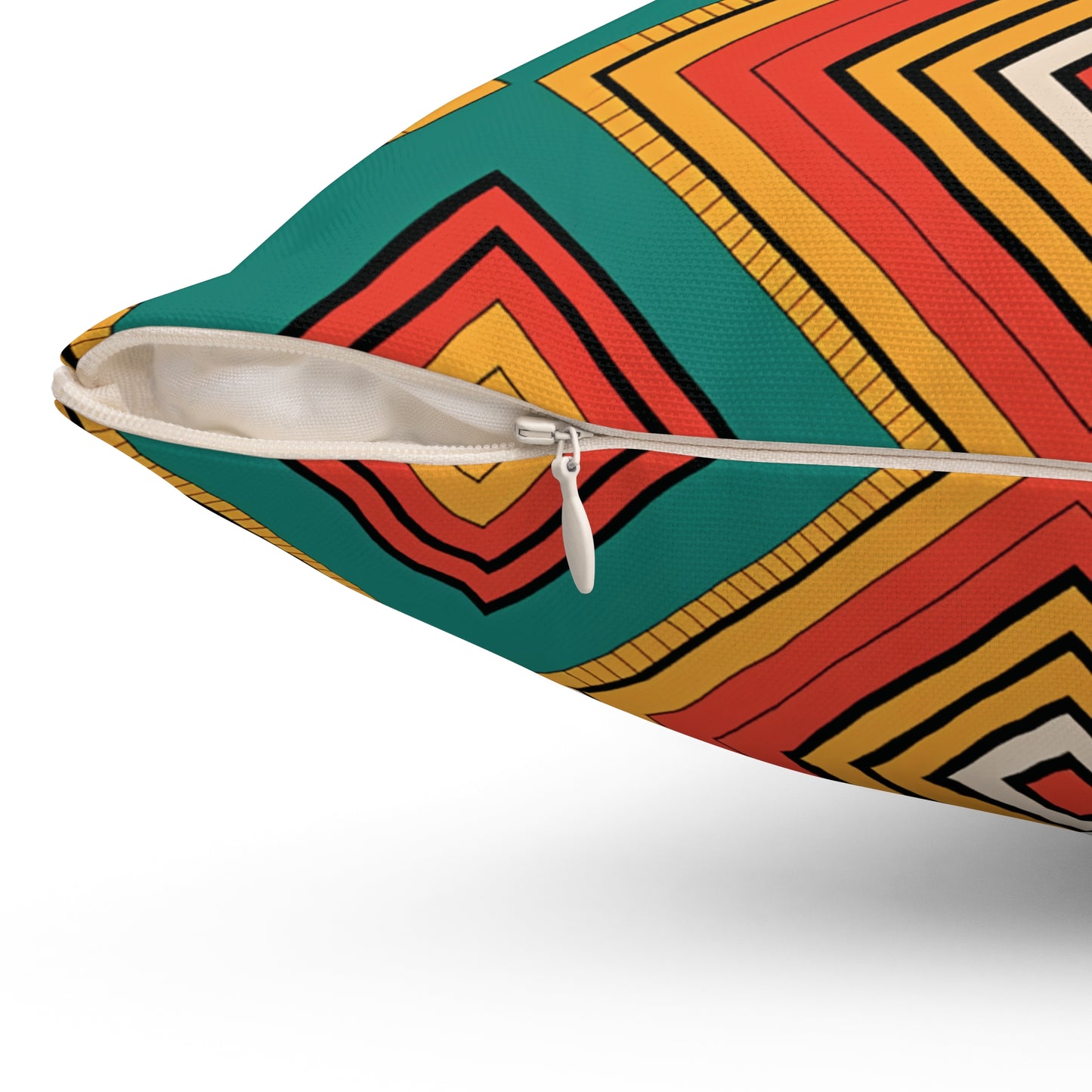 Close-up of an African-Inspired pillow with a visible white zipper. The fabric displays vibrant patterns of concentric squares in red, yellow, orange, black, and green on a white background, making it a striking piece for home decor.