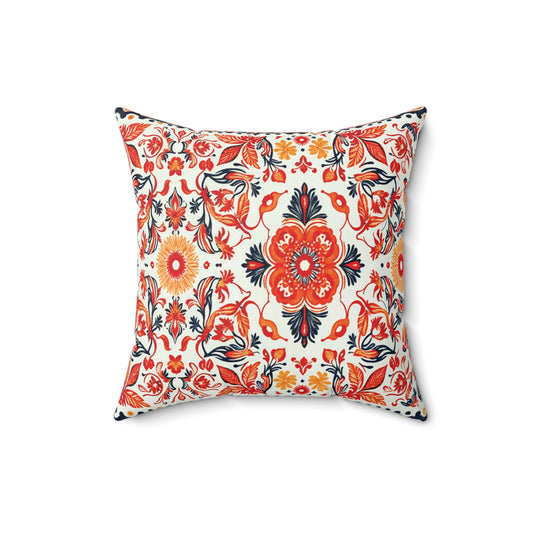 Square faux suede pillow with a vibrant, symmetrical floral pattern in red, orange, yellow, navy blue, and black on a white background. This African inspired accent pillow features bold central flowers framed by lively leaves and vines.