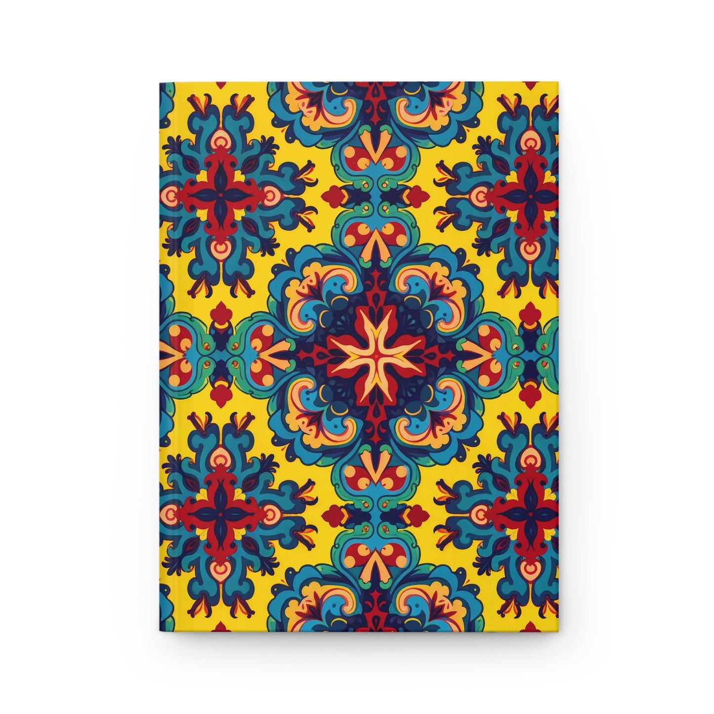 A culturally-rich notebook with a vibrant cover featuring an ornate, symmetrical pattern in blue, red, teal, and orange on yellow. The design blends floral and geometric shapes into a repeating, kaleidoscopic motif.