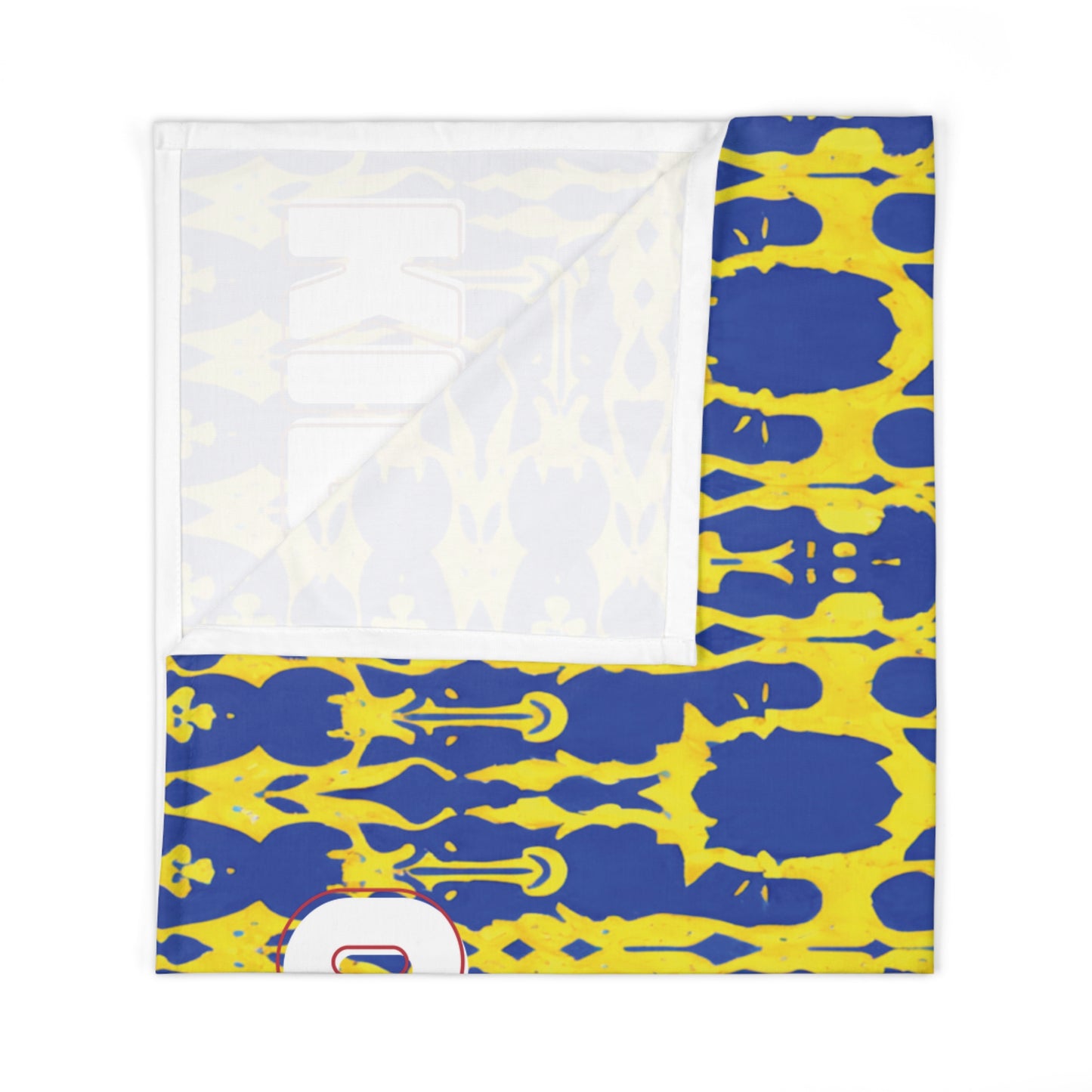 A custom swaddle blanket featuring a blue and yellow abstract, symmetrical pattern with repeating inkblot shapes. In the lower left, a large white number outlined in red and blue is visible. The corner folds to reveal the plain white underside.