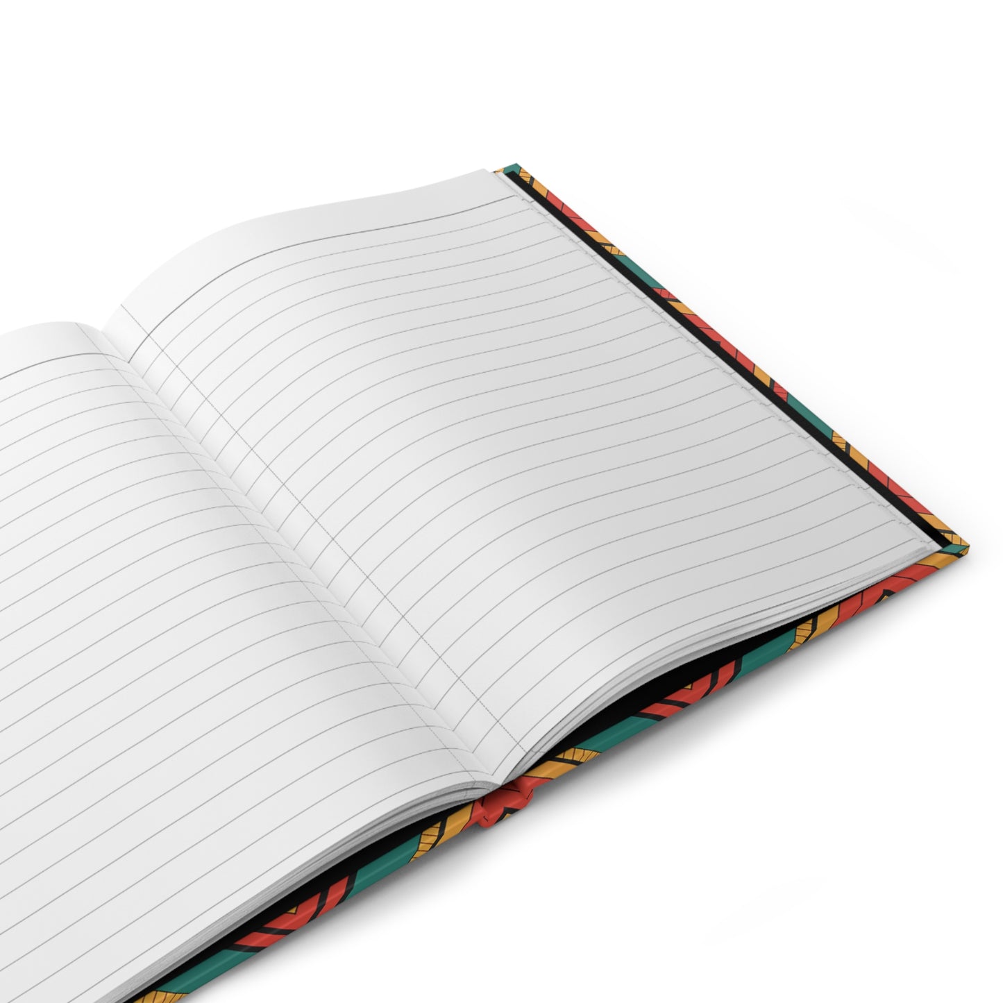An open lined writing journal lies on a white surface. The visible pages are blank, and the edge of the cover features a colorful, floral pattern with red, yellow, and green accents. The notebook is viewed from a slight angle above.