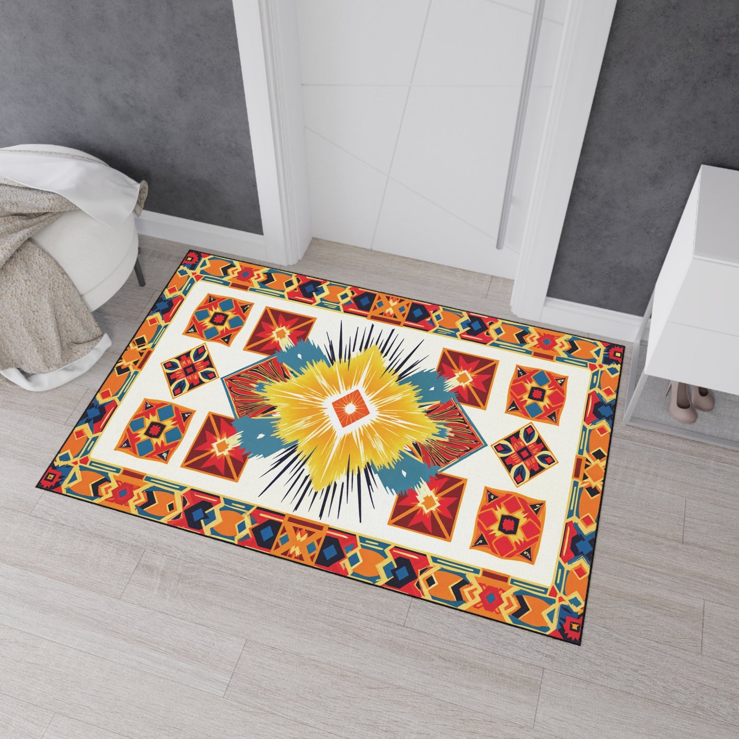 A colorful rectangular rug with bold geometric patterns inspired by African-inspired aesthetics in yellow, red, blue, orange, and black lies on a light wood floor. The rug features a non-slip rubber backing and is centered in front of a white doorway.