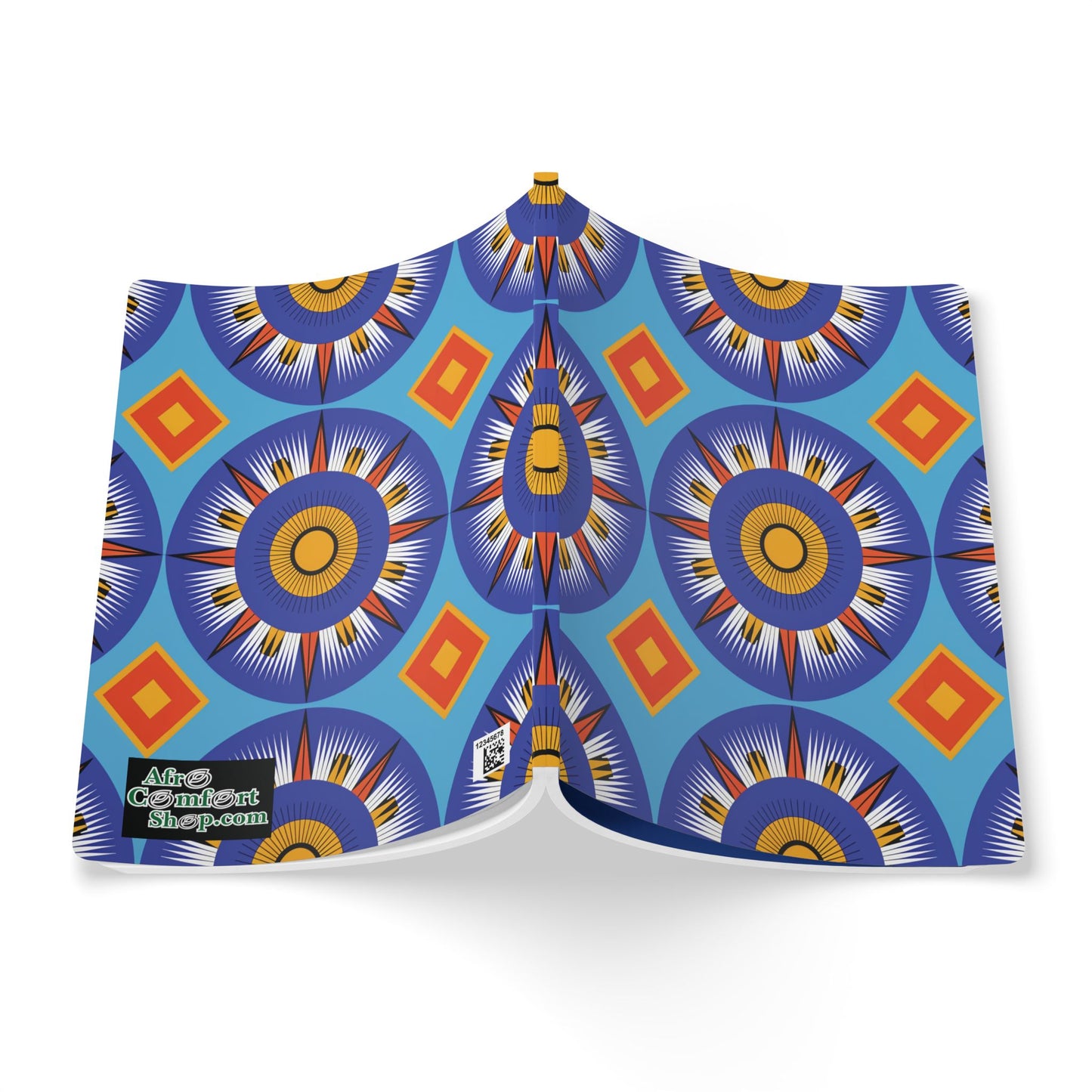 An open African-inspired journal displays a vibrant cover with blue, yellow, and orange circular geometric patterns, featuring starburst and diamond shapes on a light blue background. The bottom left corner shows a small green and black logo. The book casts a light shadow.