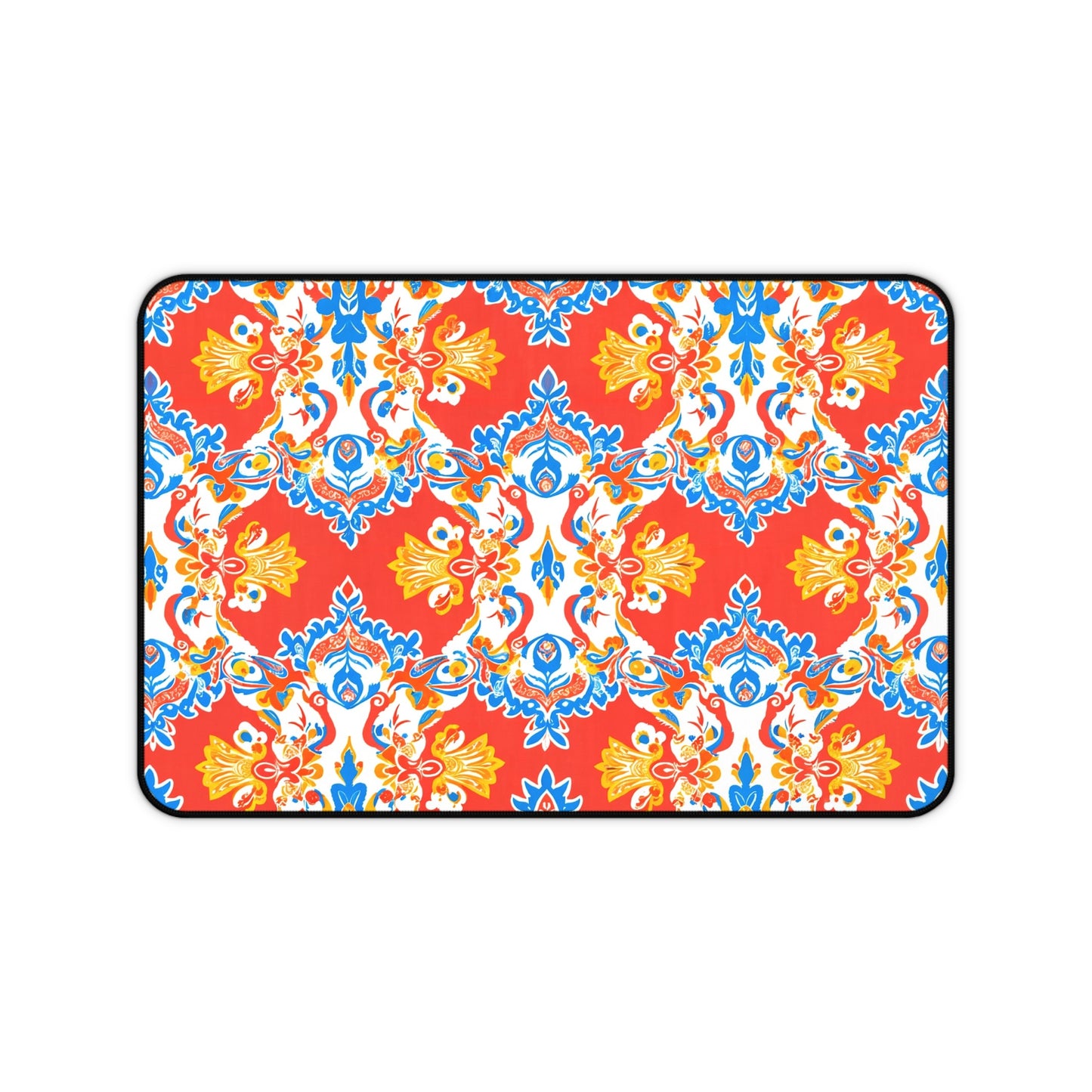 Rectangular neoprene desk mat with a bold red background features an ornate, symmetrical floral and vine pattern in blue, yellow, and white. This vibrant, Mediterranean-inspired non-slip desk pad is a perfect colorful workspace accessory.
