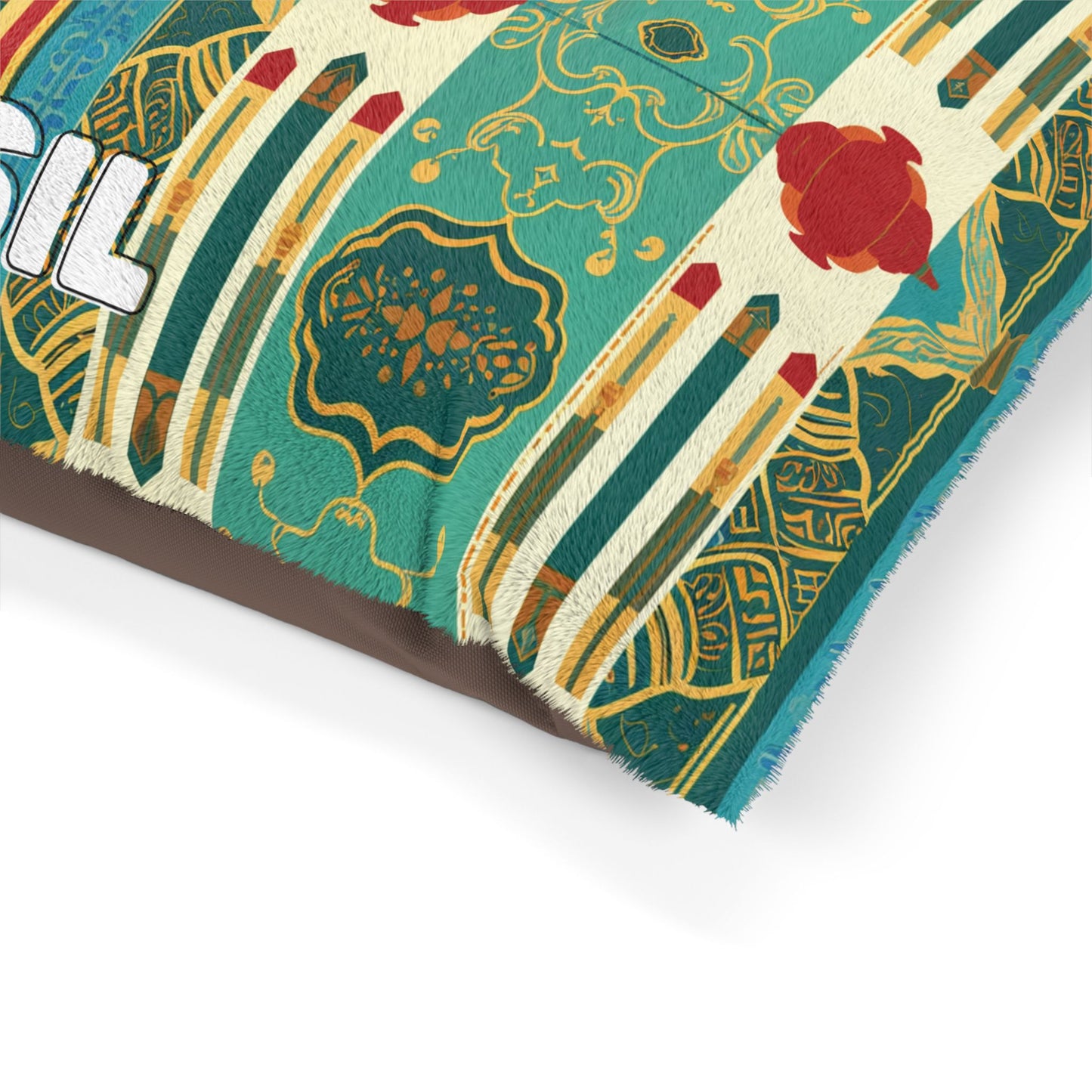 A close-up of a colorful cushion with intricate teal, green, and gold geometric and floral patterns, red accents, and part of the word Brazil in bold, white text—crafted for luxurious comfort and durable construction—against a plain background.