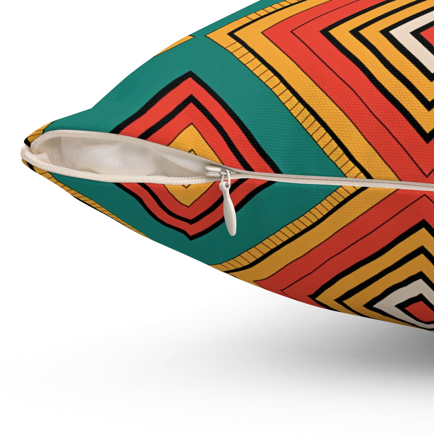 Close-up of an African-inspired pillow with a white zipper partially open. The pillowcase showcases vibrant patterns with bold concentric diamonds in red, yellow, orange, black, and green—perfect for adding flair to your home decor.