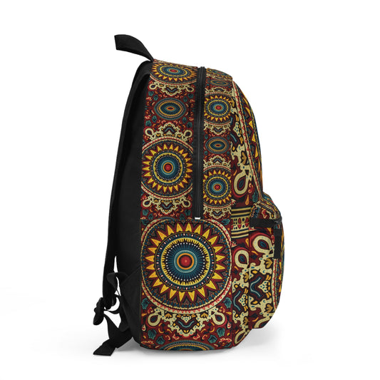 A boho chic rucksack featuring intricate mandala patterns in yellow, blue, red, and green on a black background. The side view displays a zippered main compartment and pocket, both adorned with detailed geometric and circular designs.