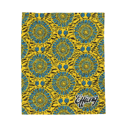 A vibrant African-inspired blanket with blue and teal circular flower shapes outlined in black, set against a bright yellow background with brown streaks. “Effiong” appears in bold white script, perfect as a custom name blanket for any space.
