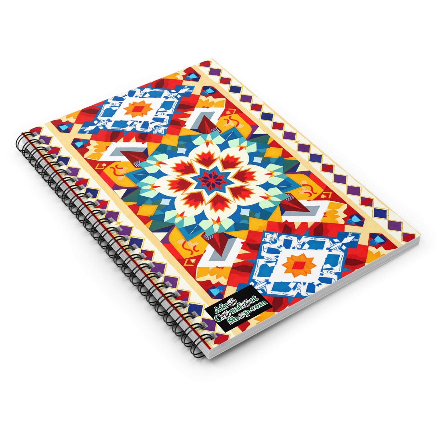 A premium writing journal, this African-inspired spiral notebook features a vibrant geometric cover with a large central starburst pattern in red, blue, yellow, and white, surrounded by culturally inspired designs and diamond borders.