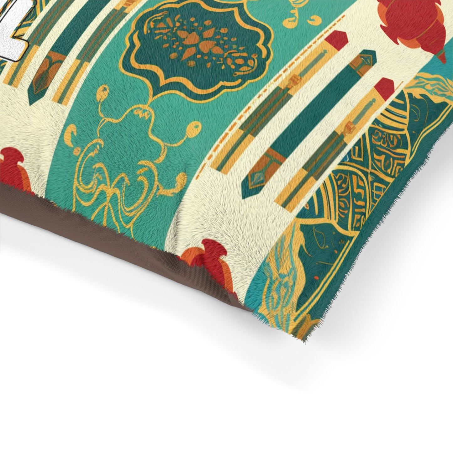 Close-up of a cushion with a colorful, intricate pattern featuring green, gold, and red geometric and ornate designs. The surface appears soft and textured, with visible faux fur fibers, luxurious comfort, and symmetrical decorative motifs.