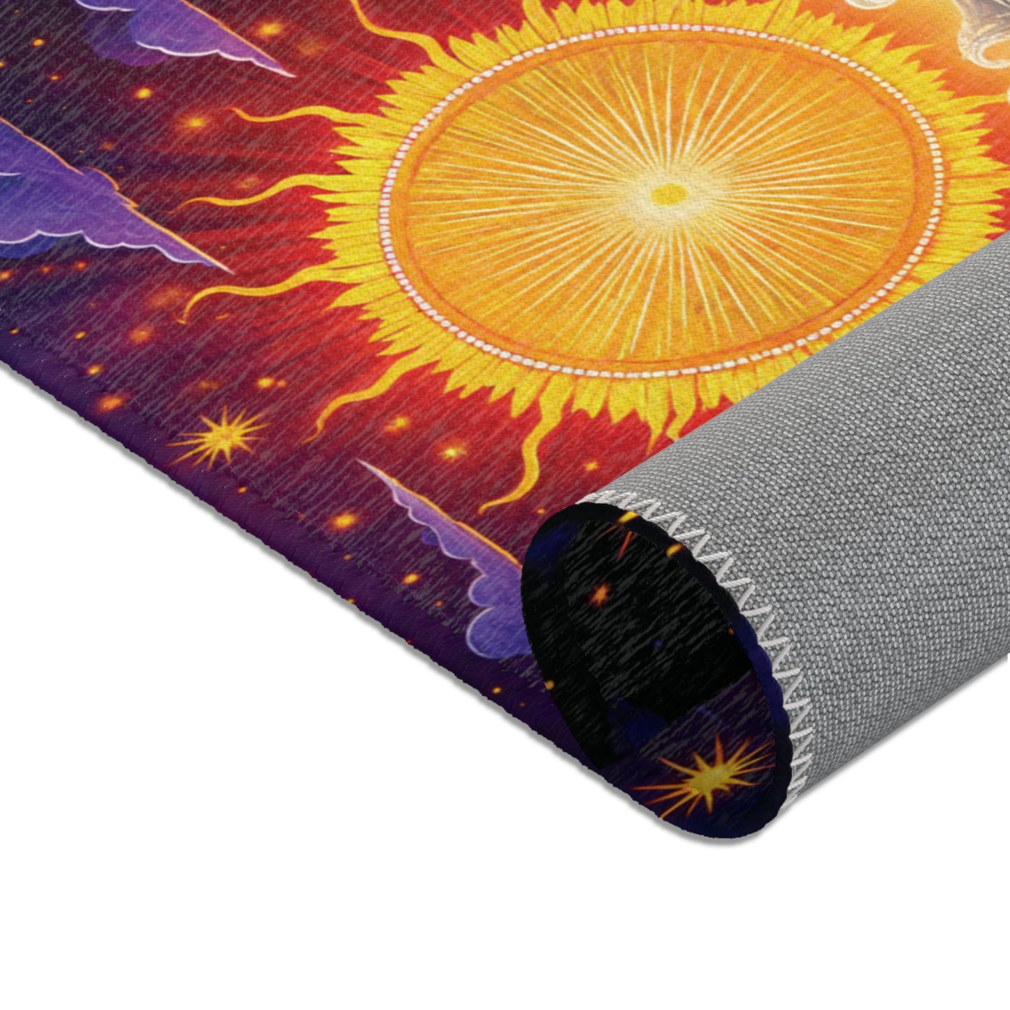 A close-up of a colorful mat, inspired by African design rugs, shows a radiant yellow sun with orange and red rays, purple clouds, and stars. The mat’s edge curls up, revealing a durable polyester underside with white stitching.