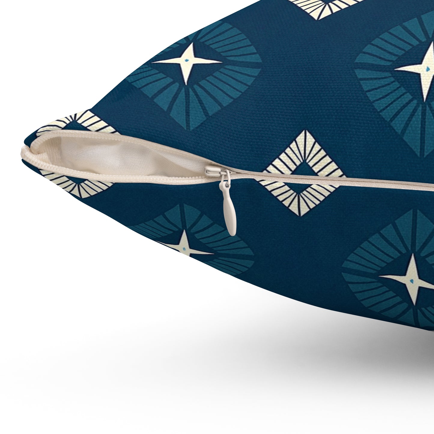 Close-up of a vibrant pillow with a visible beige zipper partially open. The blue cover, inspired by African-Inspired pillows, features geometric starburst patterns in teal and cream, with textured fabric and focus on the zipper area—perfect for unique home decor.