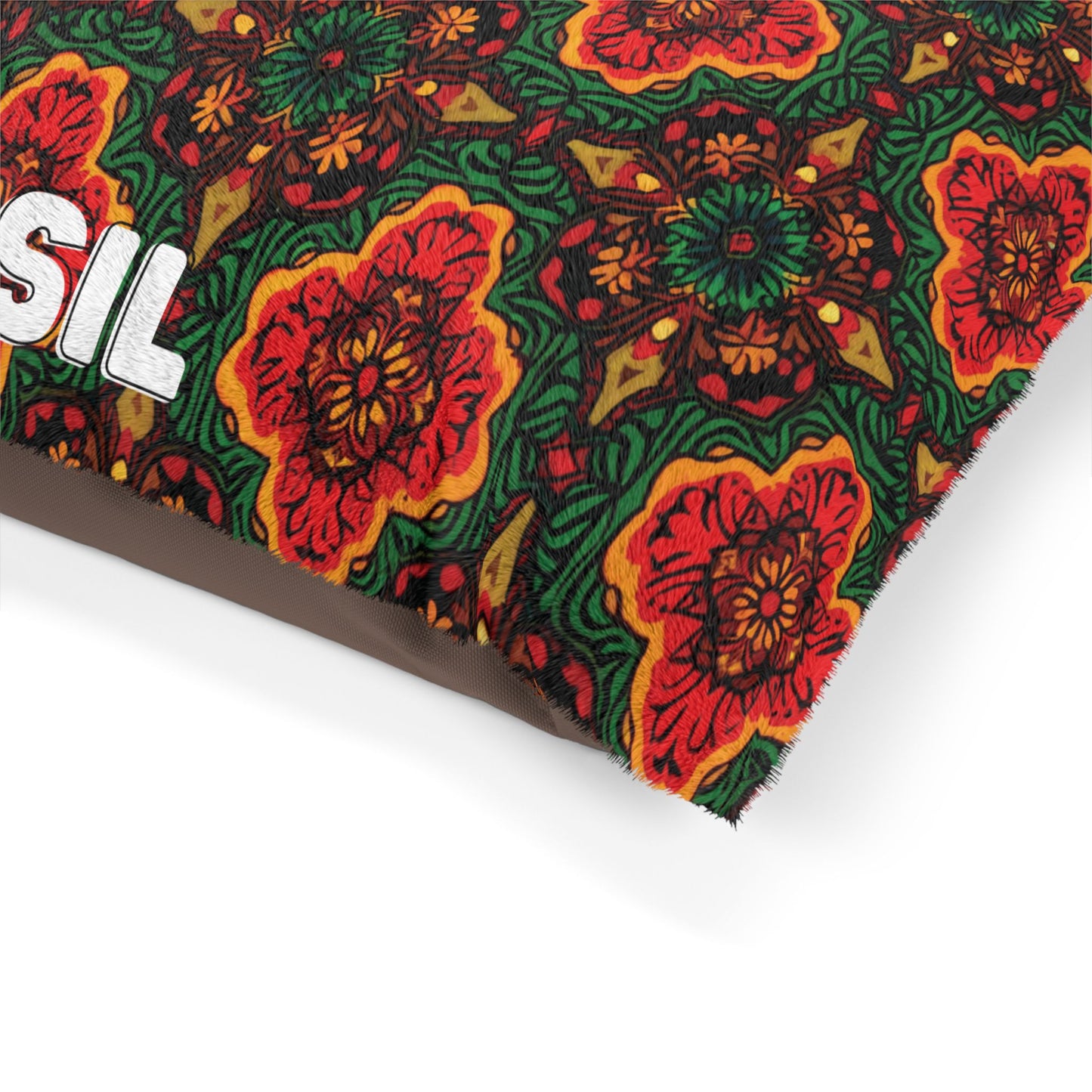 Close-up of an African-inspired fabric with a vibrant, symmetrical floral pattern in red, orange, yellow, and green. The texture appears soft and fuzzy. A partial bold white text, “SIL,” is visible on the left side of the patterned fabric.