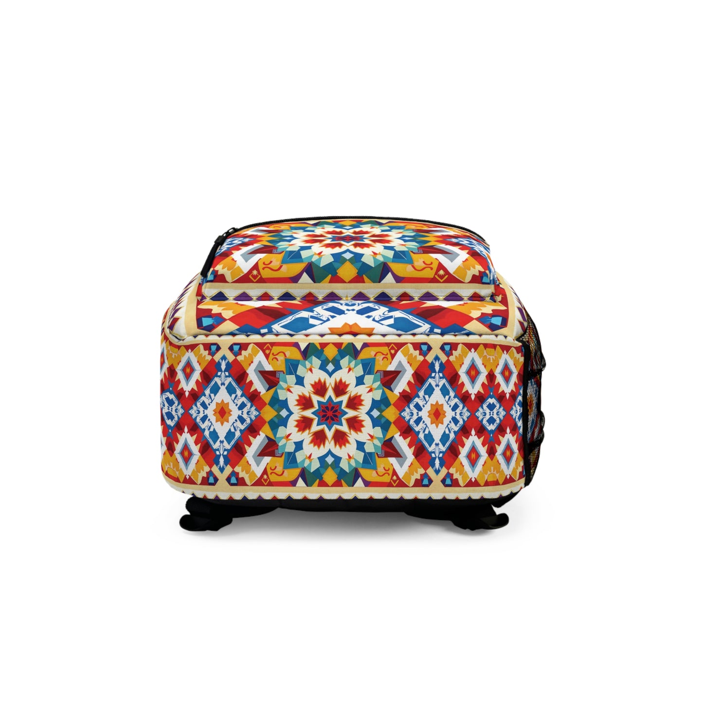A colorful, square African-inspired backpack with black feet, featuring geometric and floral patterns in red, blue, yellow, and white. The bag has a black zipper on top and intricate, symmetrical designs on all visible sides.
