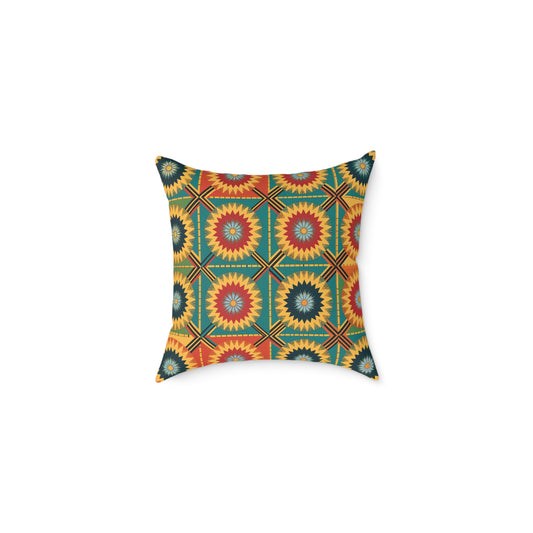 A square, African-inspired pillow with a geometric pattern of red, yellow, green, and blue starburst shapes inside hexagons. This vibrant accent pillow is arranged in a symmetrical design and shown on a plain white background.