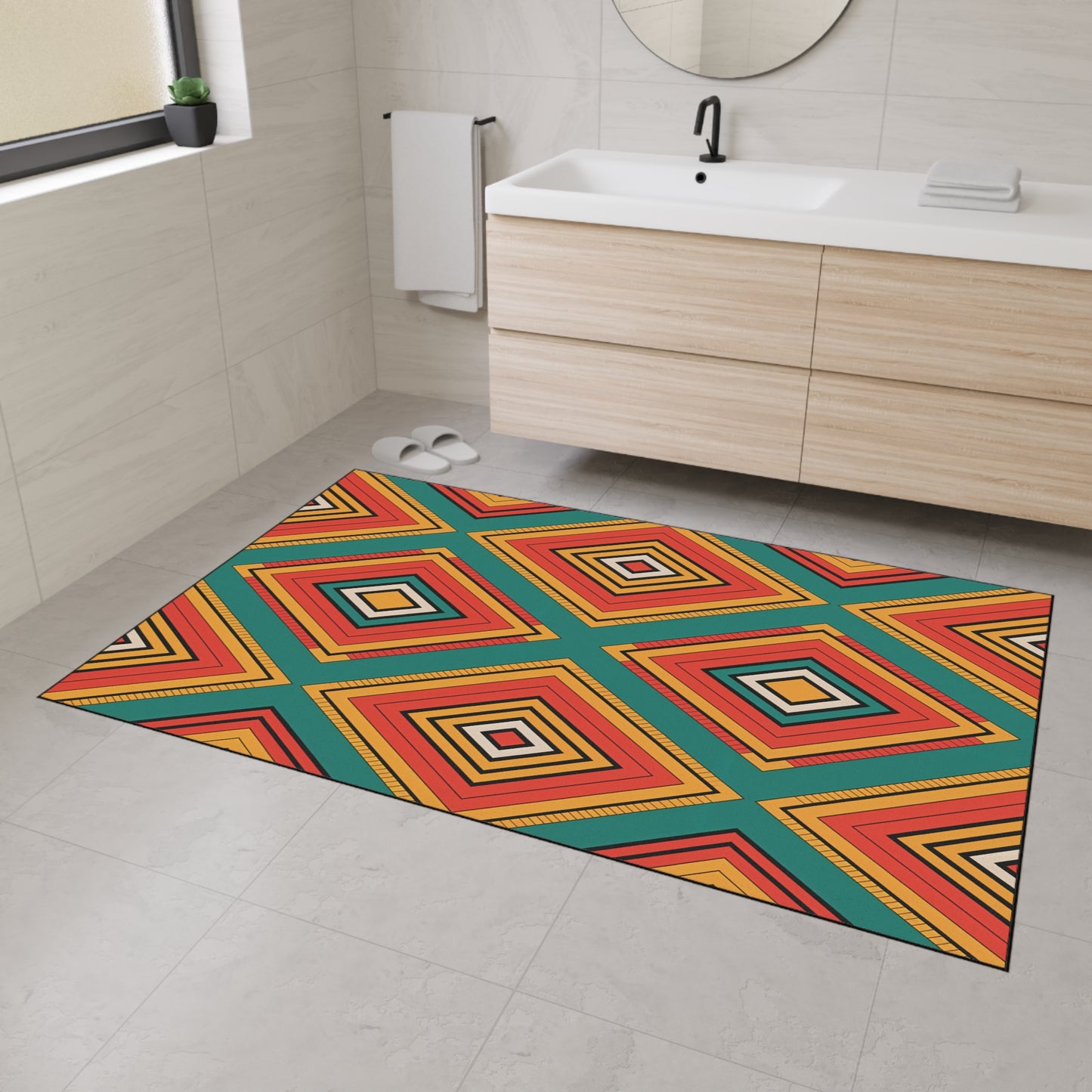 A modern bathroom with light beige tiles, a floating wood vanity, and a round mirror features a colorful geometric rug with African-inspired aesthetics and non-slip rubber backing. White slippers and a towel are near the sink as sunlight streams through the window.