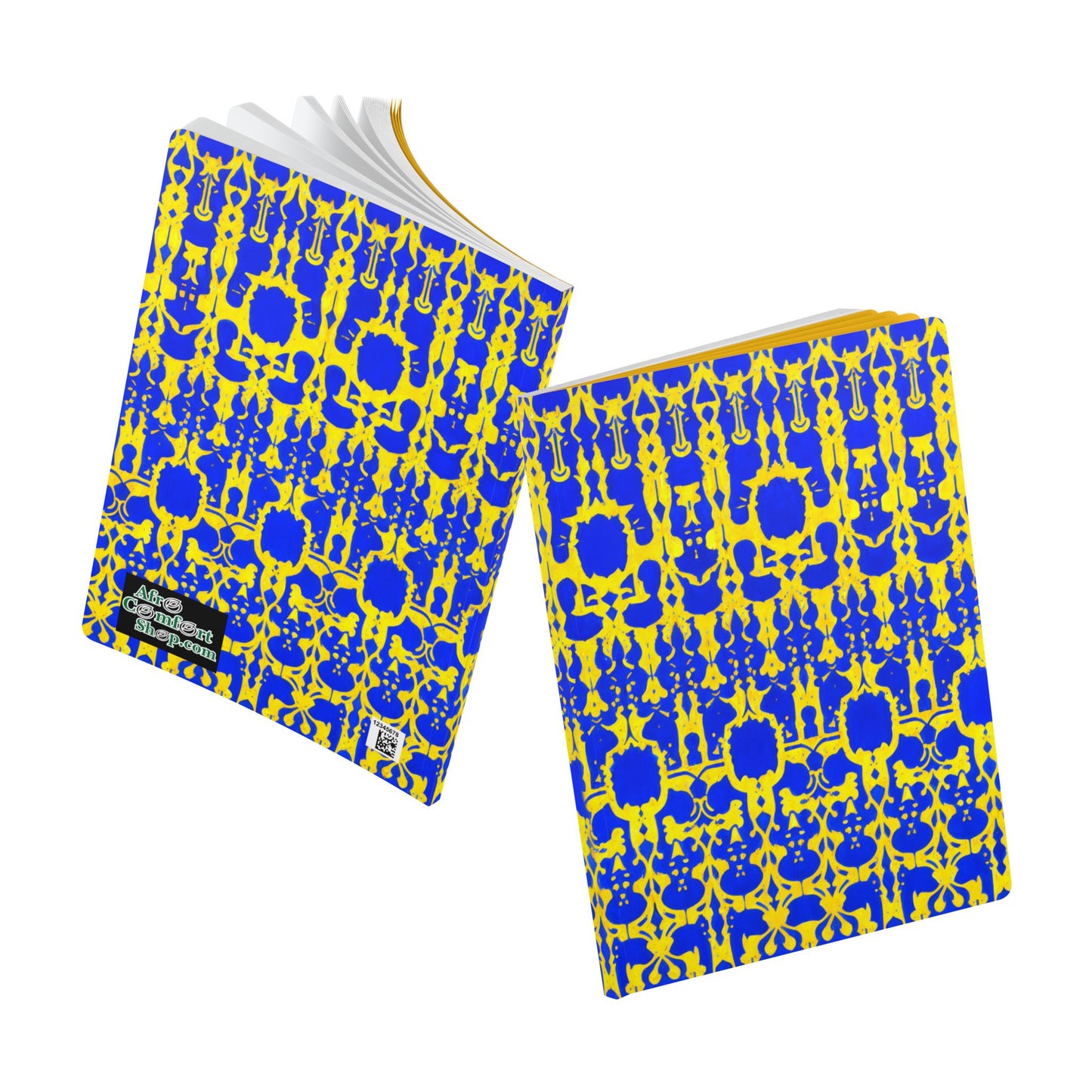Two notebooks with vibrant blue and yellow ornate patterns, inspired by African designs, are shown. One African-inspired journal is closed, the other open to white pages. Both feature a black label with colorful icons and white text in the corner.