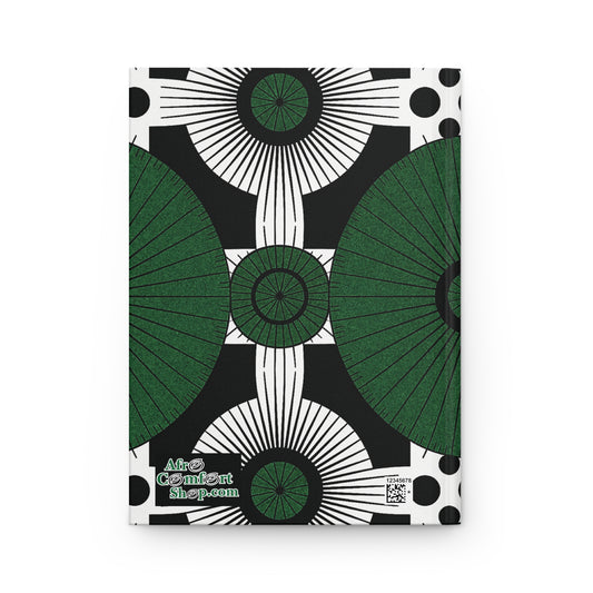 A hardcover journal with a bold geometric pattern in green, black, and white. Large green semicircles, starburst shapes, and black dots create an abstract symmetrical design on this African-inspired journal. “AfroComfArtshop.com” is printed in a stylized font below.