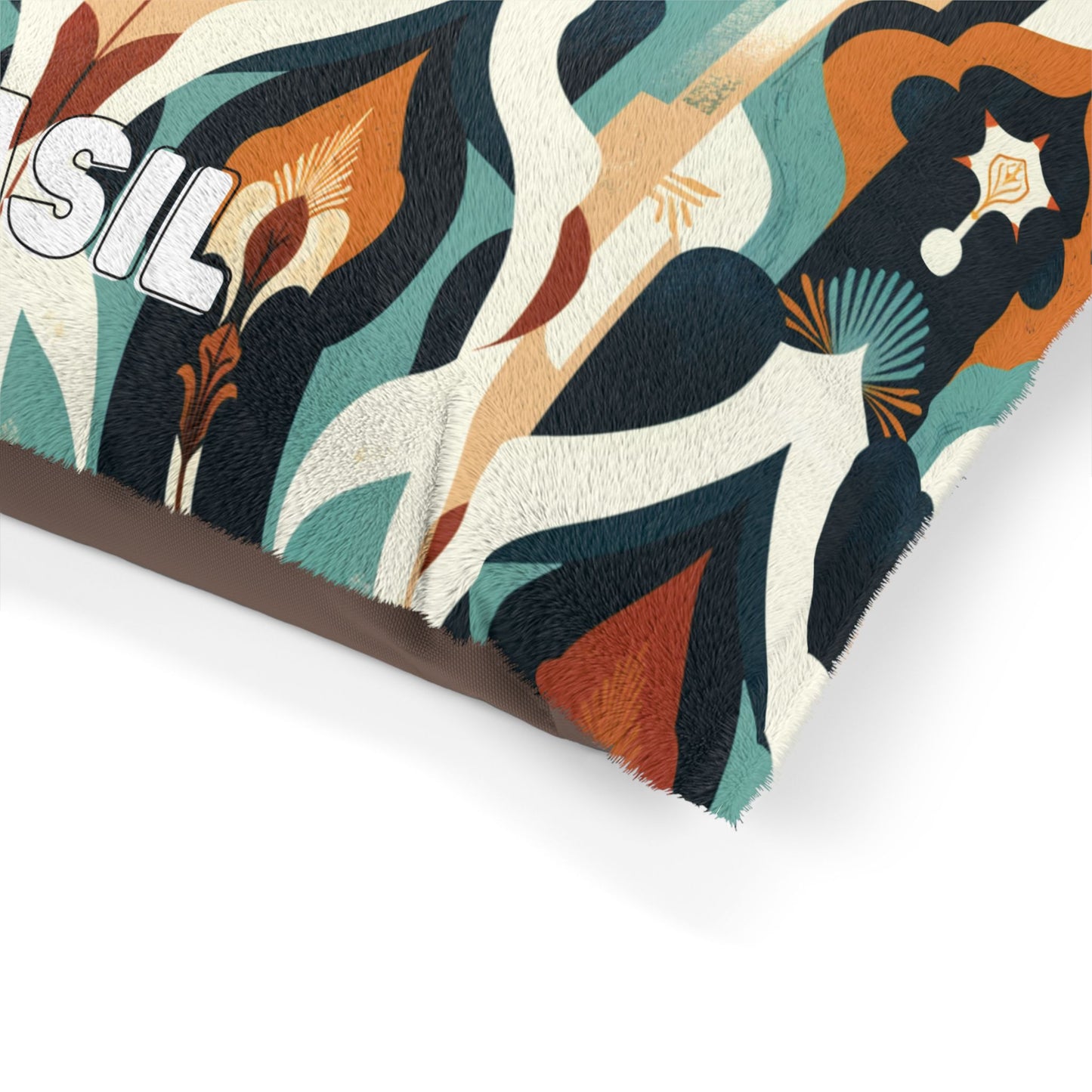 A close-up of a pillow with a textured cover featuring abstract, wavy shapes in teal, cream, orange, black, and brown. The durable construction highlights organic forms and stylized plant-like elements; partial white text SIL appears on the left.