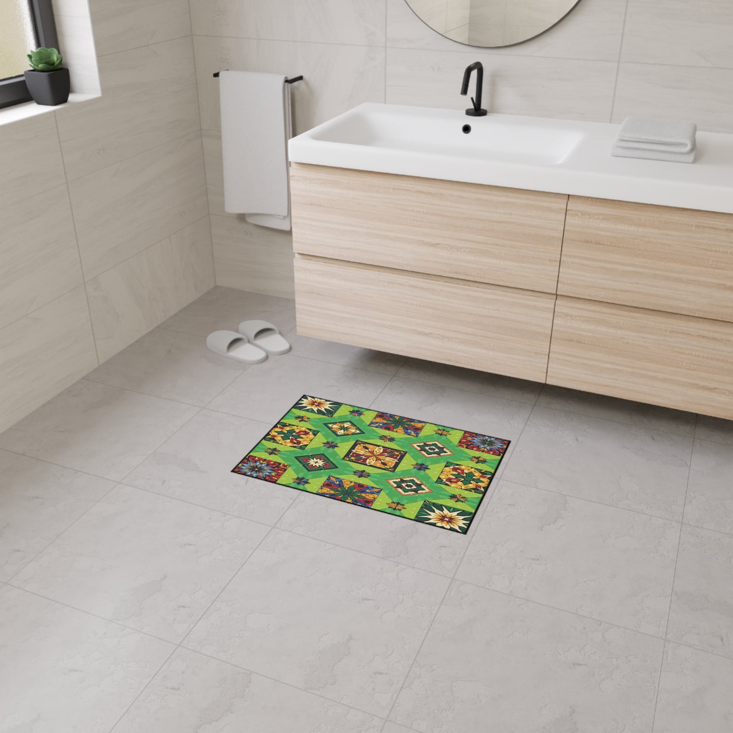 A modern bathroom with light tile floors, a floating wood vanity, white sink, and black faucet. On the floor is a colorful, quilt-style mat with non-slip rubber backing—perfect for adding both safety and personalized home décor.