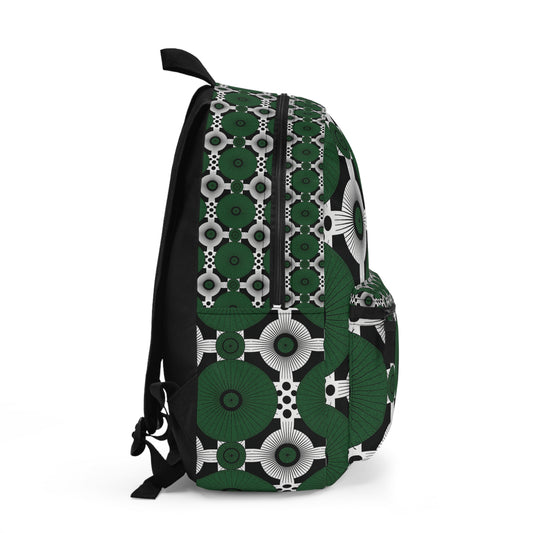 A side view of an African-inspired backpack with a bold geometric pattern in green, white, and black. The design features concentric circles and star shapes, with a black zipper on the main pocket and a matching smaller front pocket.