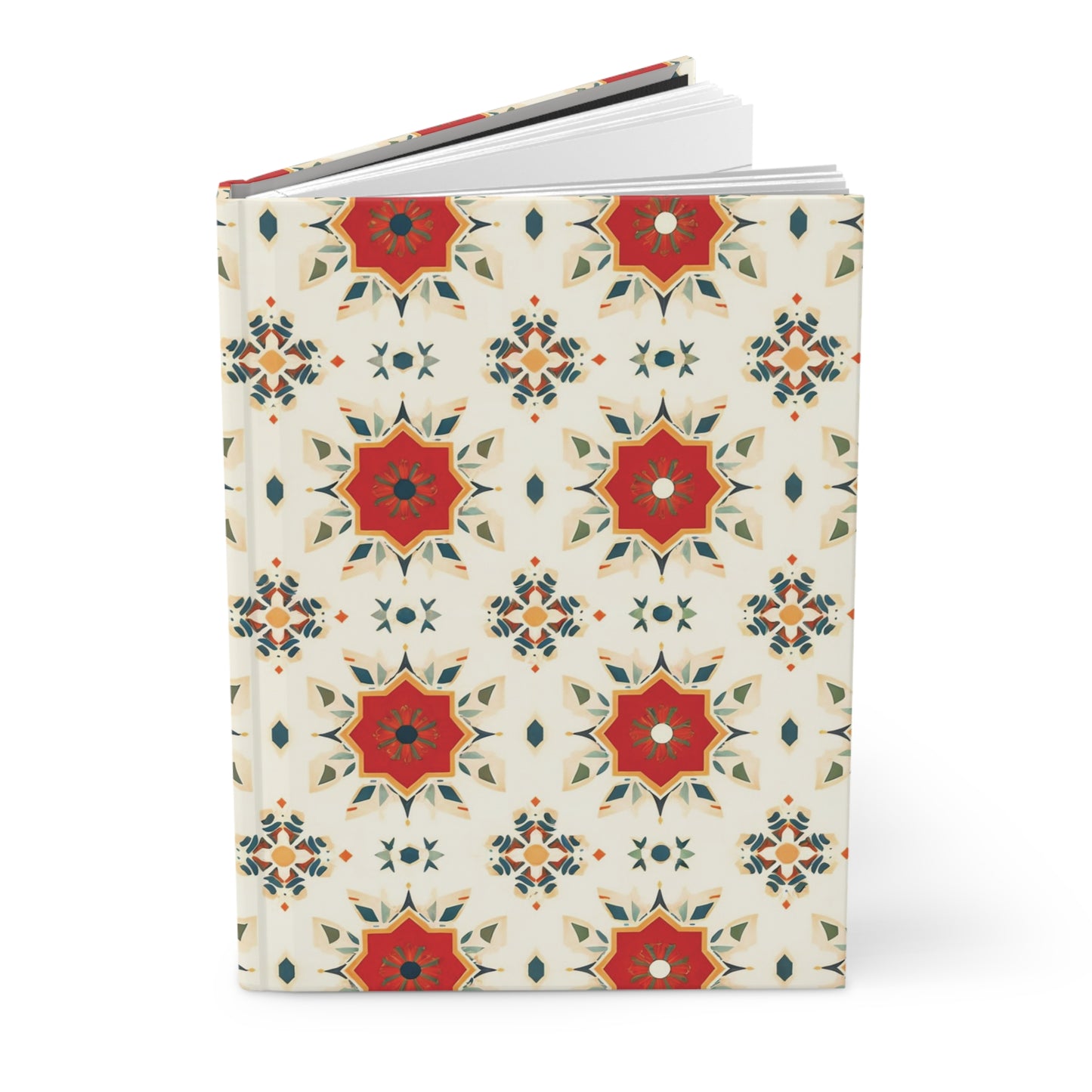 A hardcover wellness journal with a cream background features a repeating pattern of red, orange, and olive green geometric starburst motifs, creating a symmetrical and vibrant design reminiscent of an African-inspired journal. White pages are visible inside.