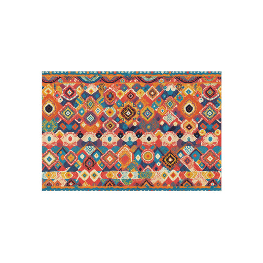 A rectangular area rug with a vibrant, African-inspired geometric pattern in red, orange, yellow, blue, and teal. The design features diamond shapes, zigzags, and small motifs for a colorful, bohemian look. The background is white.