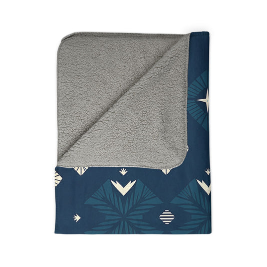 A sherpa fleece blanket with a beautiful pattern, perfect for adding cozy home decor to your space.