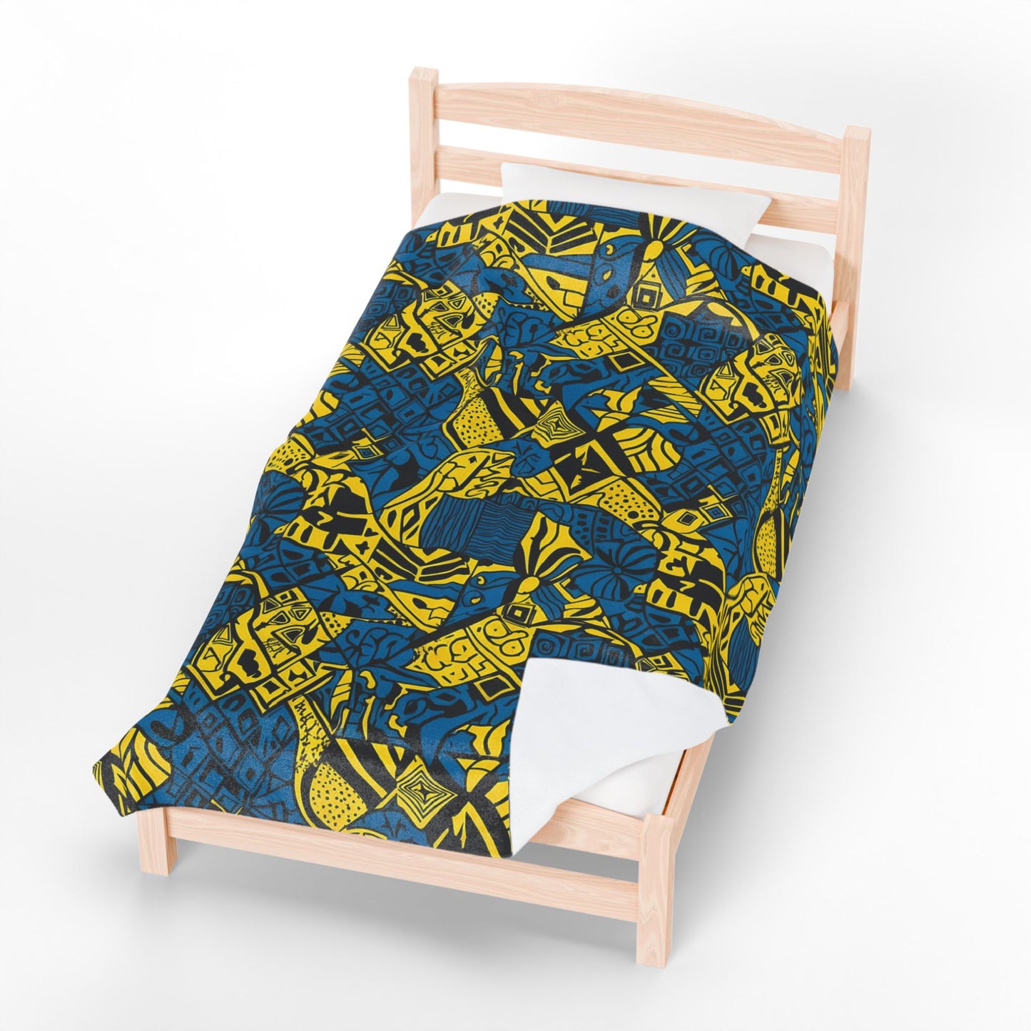 A single wooden bed with a white pillow and an African-inspired blanket featuring blue and yellow geometric and tribal-style shapes, viewed from above on a white background.