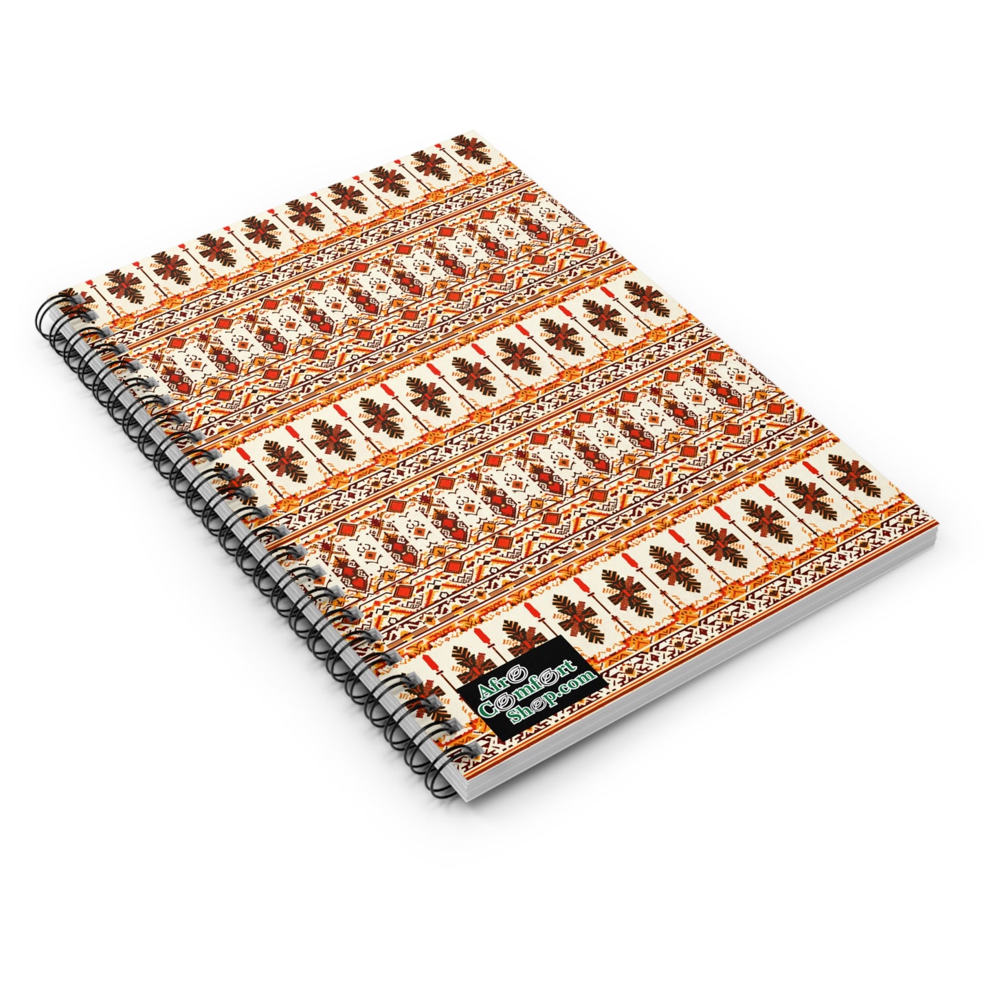 A spiral-bound African-inspired spiral notebook featuring an intricate, colorful pattern of orange, brown, and cream geometric and floral motifs. The corner displays a small, rectangular label with decorative text for a premium writing experience.