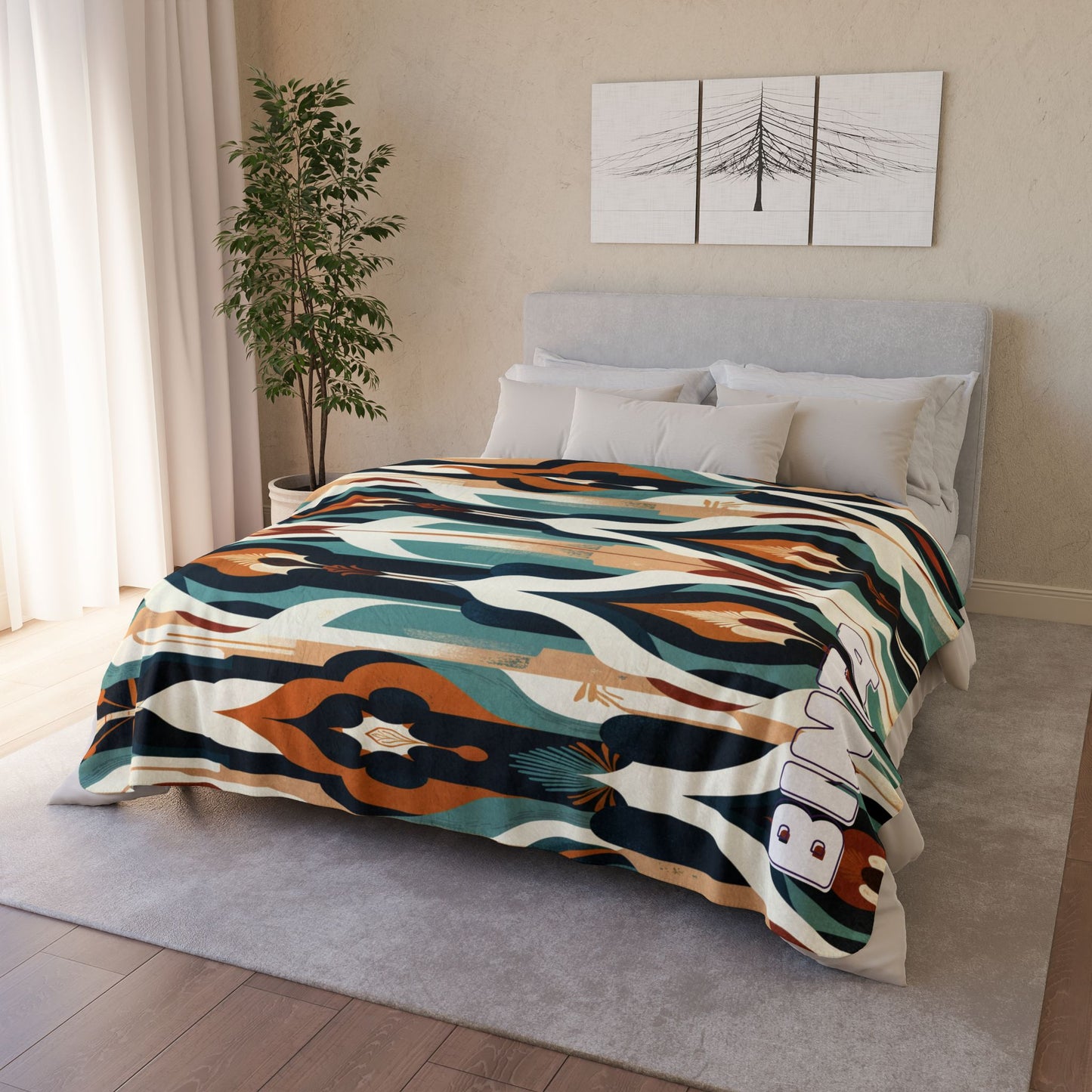 A neatly made bed with a light gray headboard, four pillows, and an African-inspired fleece blanket in green, cream, blue, brown, and orange. Above the bed hangs minimalist tree art. Beige walls and a white curtain complete the cozy room.
