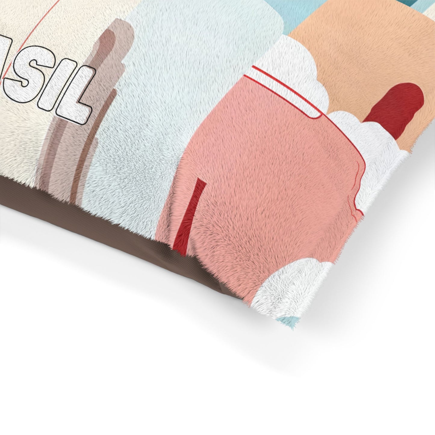 A close-up of a soft, pastel-colored blanket with a fuzzy texture. The African-inspired design features abstract shapes in pink, beige, blue, and red, with part of the word SIL in white outlined letters visible on the left. The edge is folded over.