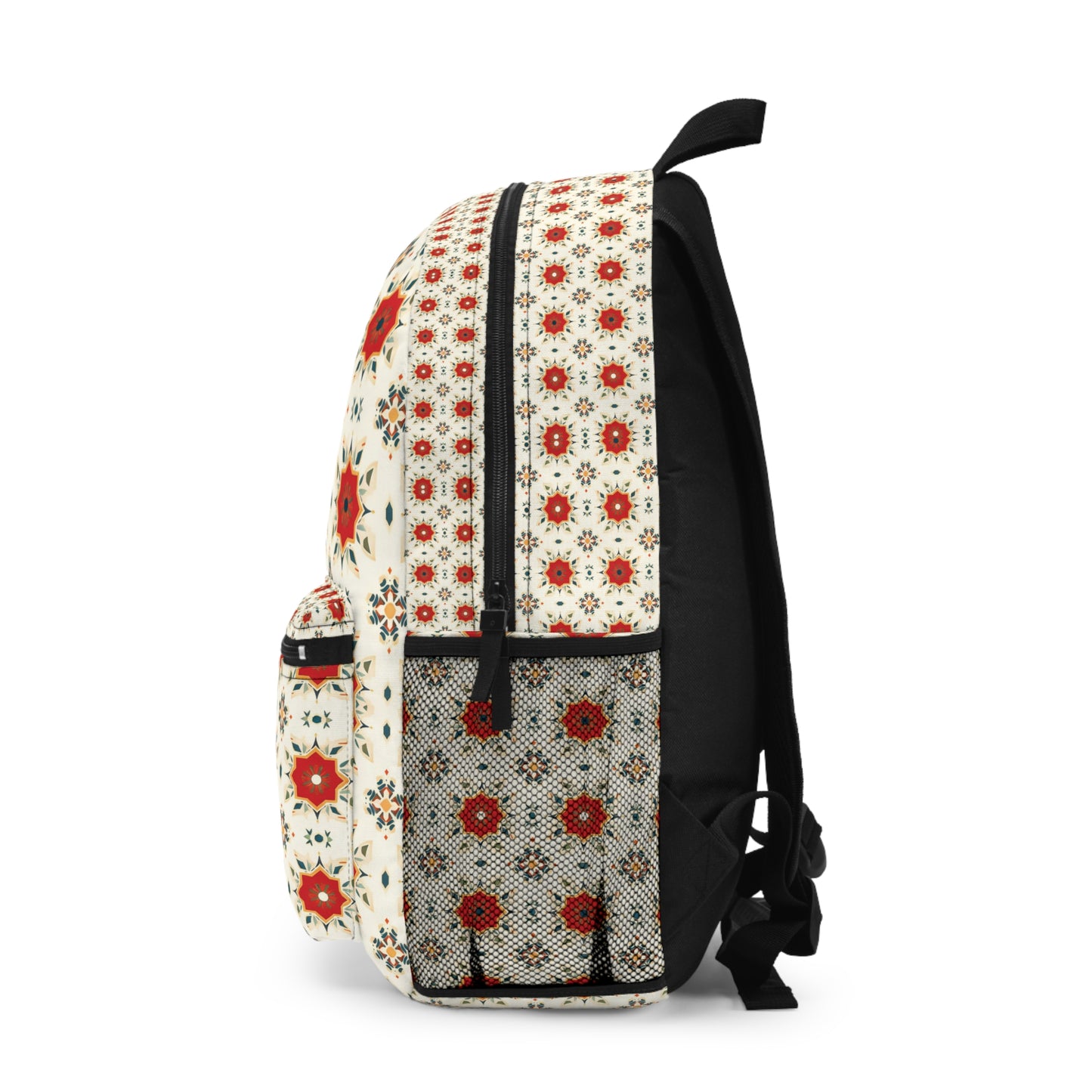 A cream-colored African-inspired backpack with black straps, featuring bold red, black, and orange geometric and floral designs. The side pocket shows a dense black-and-white motif, while the body blends boho chic prints for standout style.