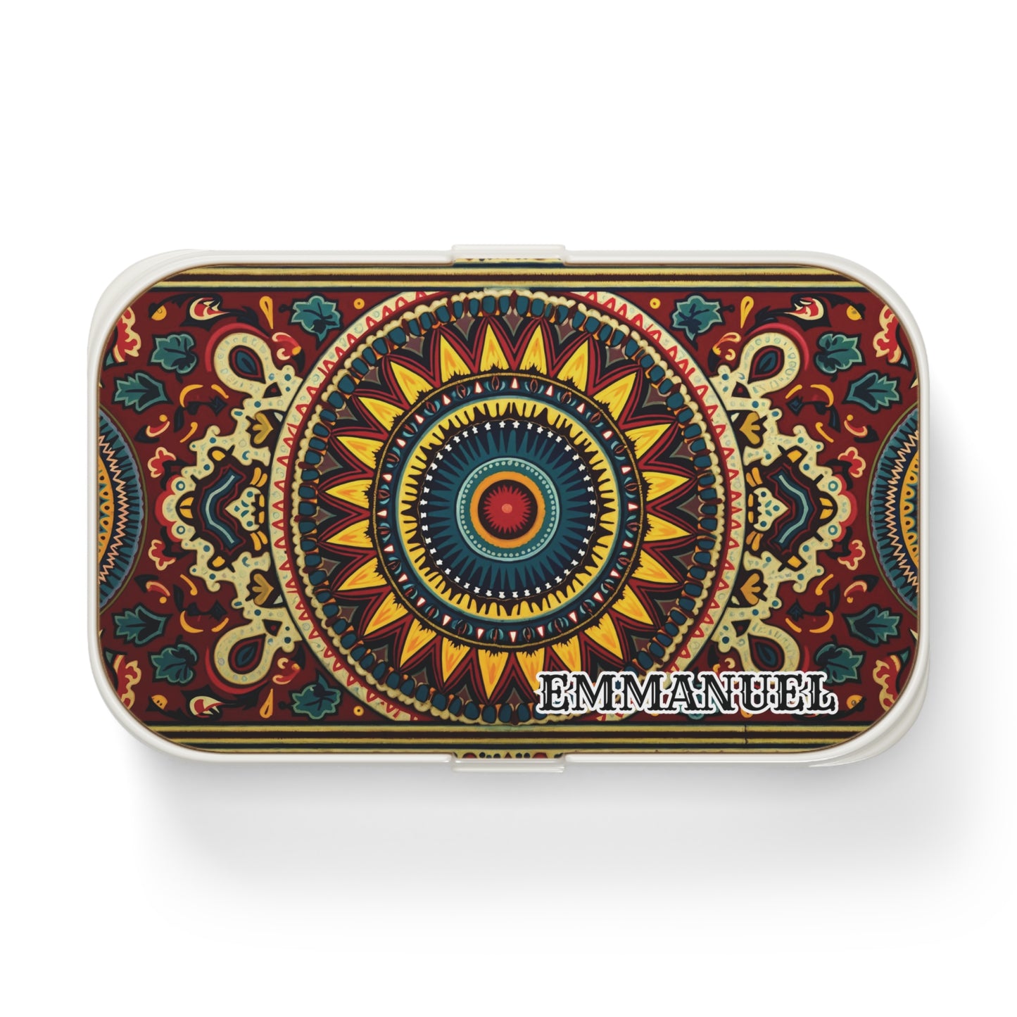 A rectangular tin box with a vibrant, symmetrical mandala pattern in red, yellow, blue, and green tones. This African-inspired lunch box features the name “EMMANUEL” in bold white letters on the bottom right corner of the lid.