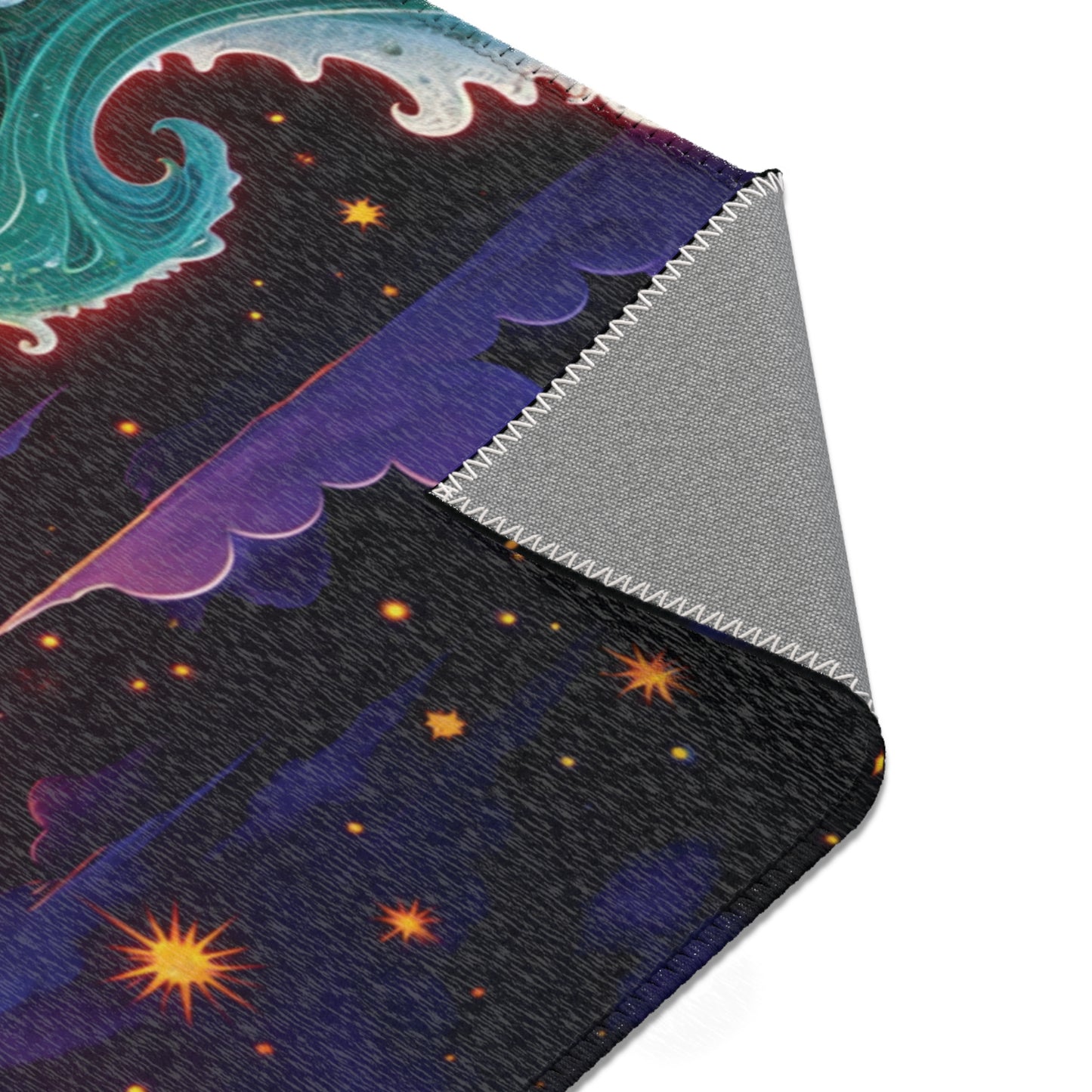 A close-up of a blanket with a colorful cosmic design, perfect for colorful home decor, featuring swirling turquoise waves, purple clouds, and orange stars. The folded corner reveals a gray underside with zigzag stitching along the edge.