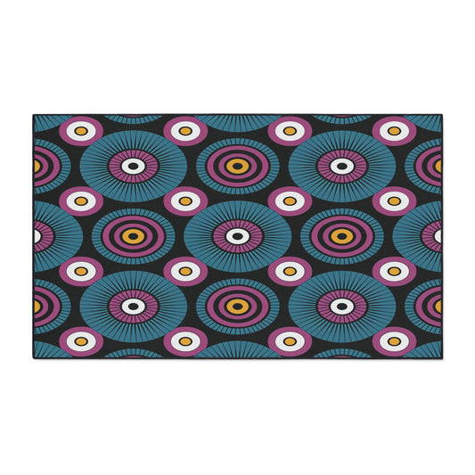 A bold, African-inspired geometric pattern features concentric circles in teal, purple, pink, yellow, and white on a black background. Radial lines and alternating rings create a rhythmic effect—perfect for custom floor mats with a non-slip surface.