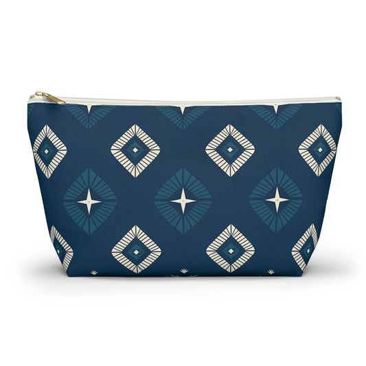 A dark blue T-bottom pouch featuring African-inspired patterns with geometric diamond motifs in cream and lighter blue. Each diamond contains a central four-pointed star, giving this cosmetic travel bag a modern, symmetrical look against a white background.