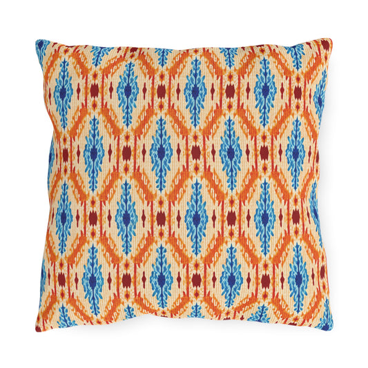 Square decorative outdoor pillow with a cream background, featuring an orange diamond and zigzag pattern, vertical blue accents, and small red details. UV-resistant and water-resistant for lasting style on your patio.