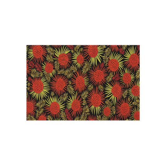 A vibrant African-inspired abstract pattern features red and yellow circular bursts resembling fireworks or flowers, with spiky radiating lines on a black background, creating a lively, energetic visual effect.