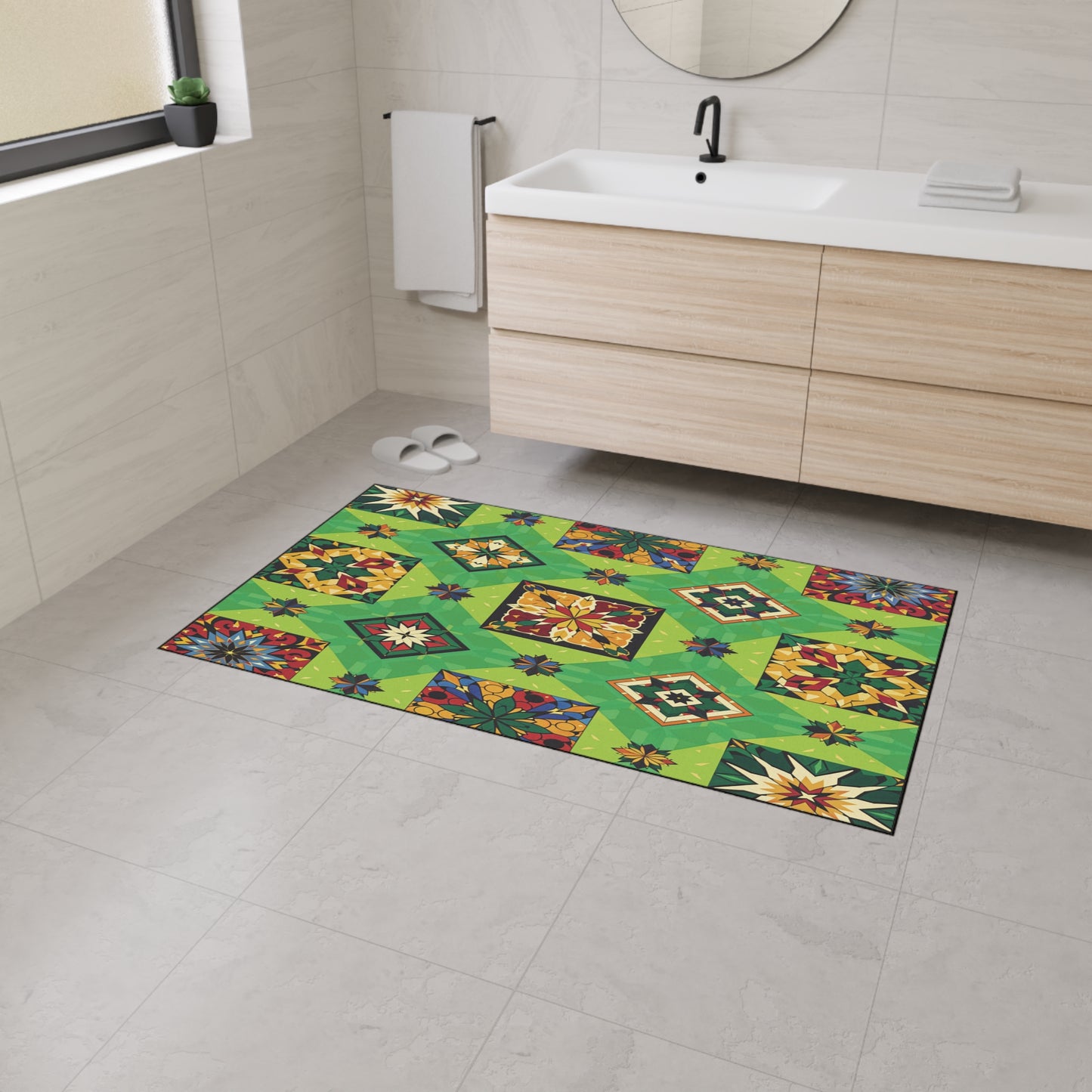 A modern bathroom with light gray tile, floating wooden vanity, and white sink features an African-inspired geometric green rug with floral and diamond shapes. The rug’s non-slip rubber backing keeps it secure on the floor.