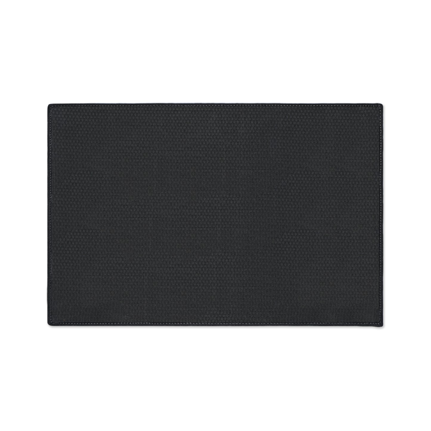 A rectangular black placemat with a subtle textured pattern and slightly rounded edges is shown on a white background. The design features visible stitching along the border and a small, repeating geometric or honeycomb detail, perfect for African-inspired décor.
