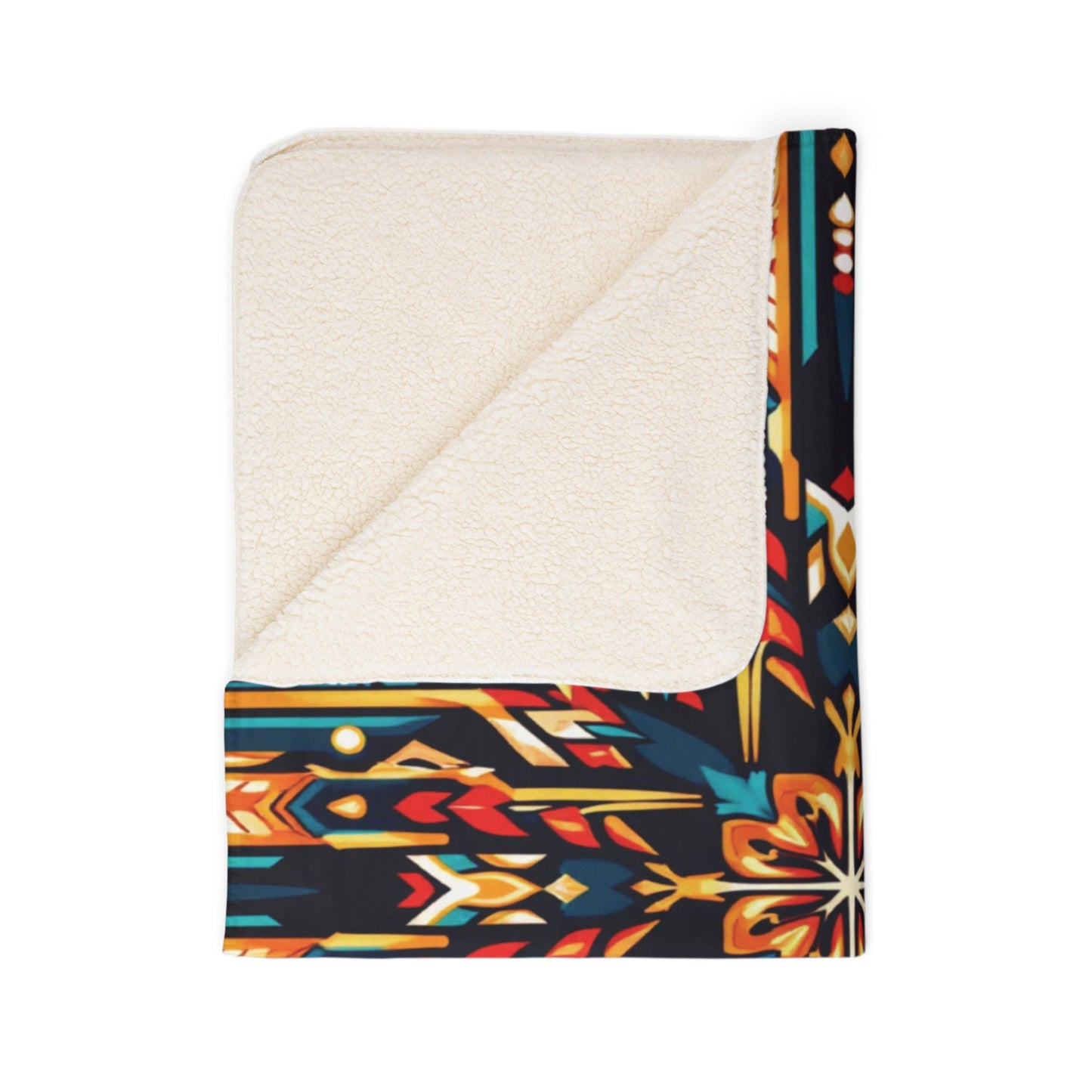 A folded sherpa fleece blanket with a soft, cream-colored lining is shown. The bold, geometric outer pattern in black, red, gold, orange, and blue adds cozy home decor flair inspired by Native American designs. One corner is turned over to reveal the lining.